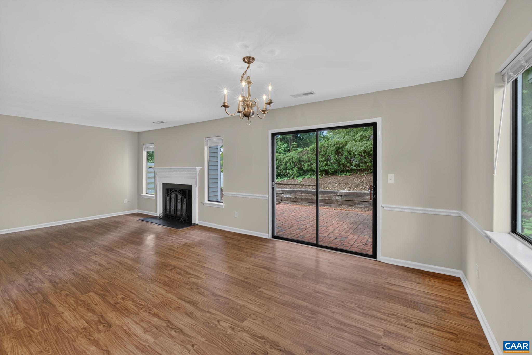 Living and dining room open out onto private patio and fenced backyard.
