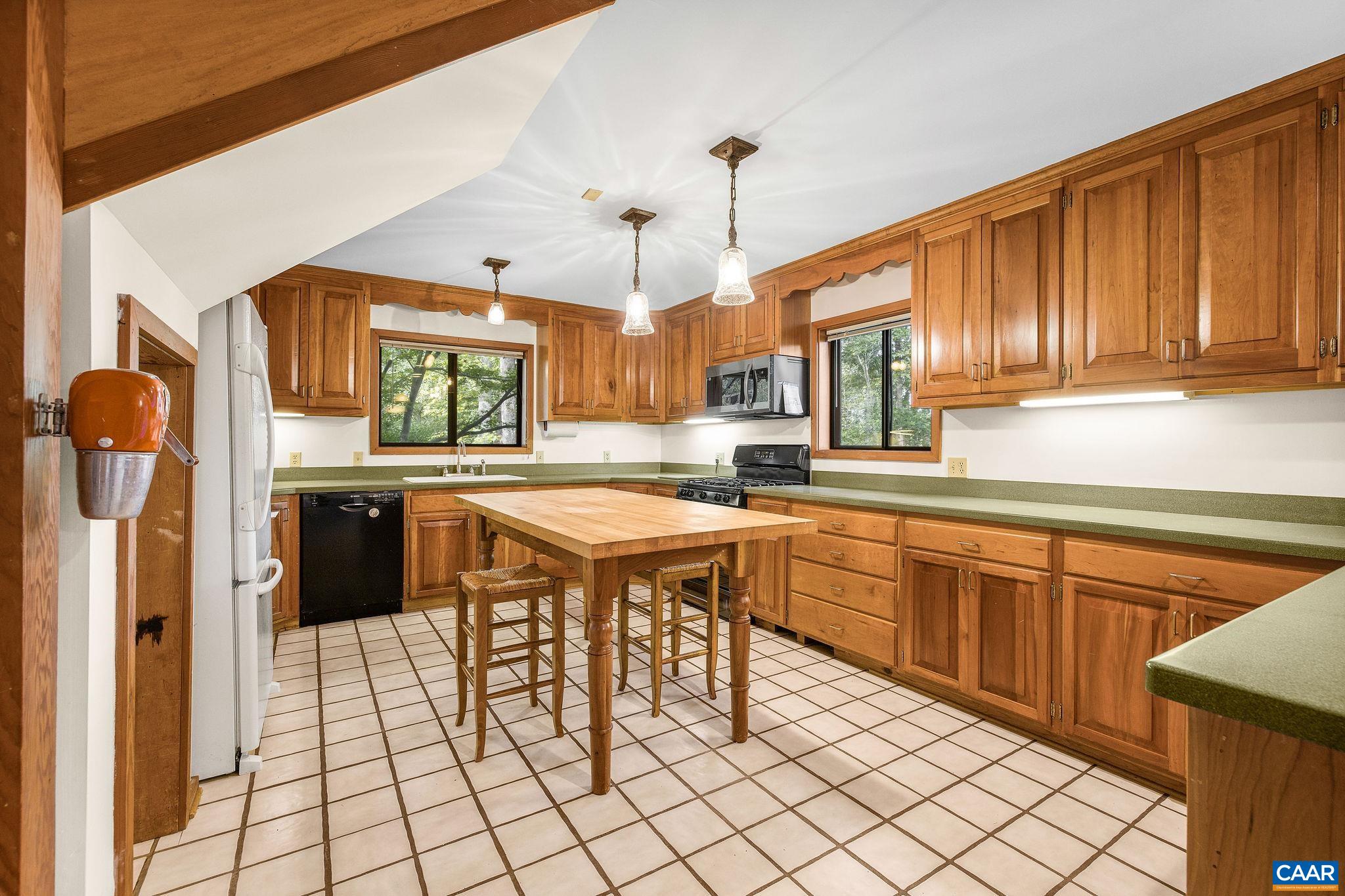 The cherry cabinets and table are custom built to match in style and scale. The table and stools convey. The cherry cabinets and table are custom built to match in style and scale. The table and stools convey.