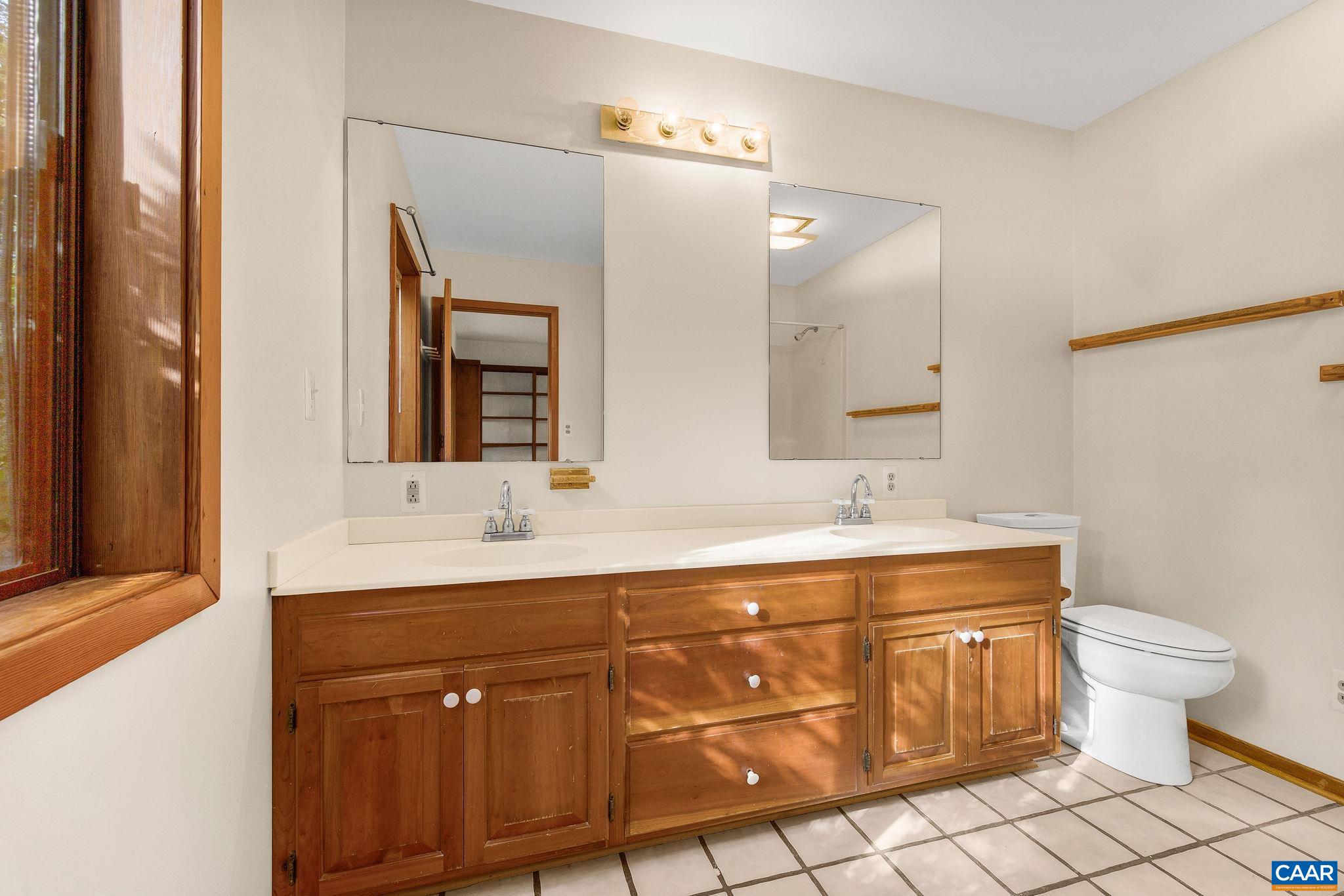 This bathroom is at the foot of the stairs leading to the Primary bedroom landing. The 2nd floor Primary bedroom has a private 1/2 bath adjacent to the room. This bathroom is at the foot of the stairs leading to the Primary bedroom landing. The 2nd floor Primary bedroom has a private 1/2 bath adjacent to the room.