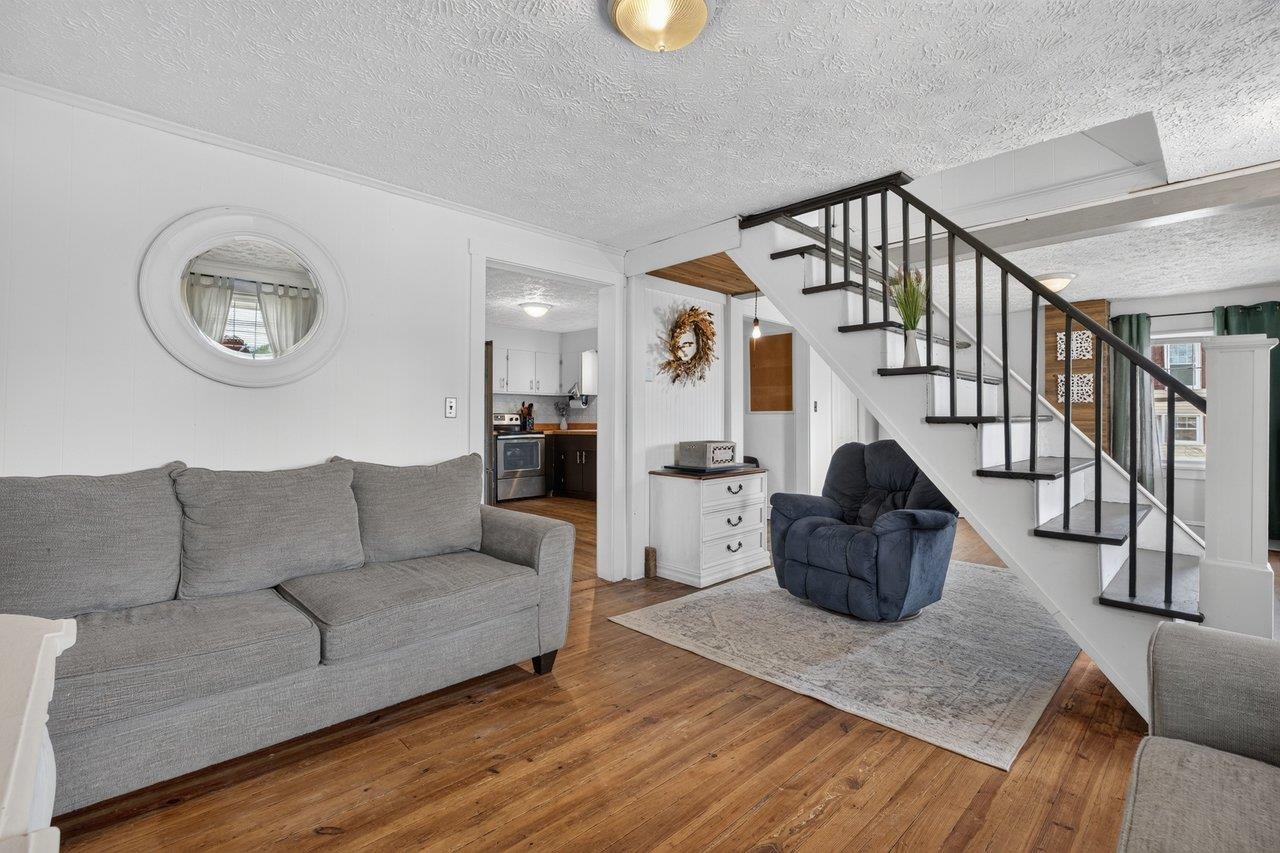 Bright, open living and dining space with rustic hardwood floors and lots of natural light. Bright, open living and dining space with rustic hardwood floors and lots of natural light.