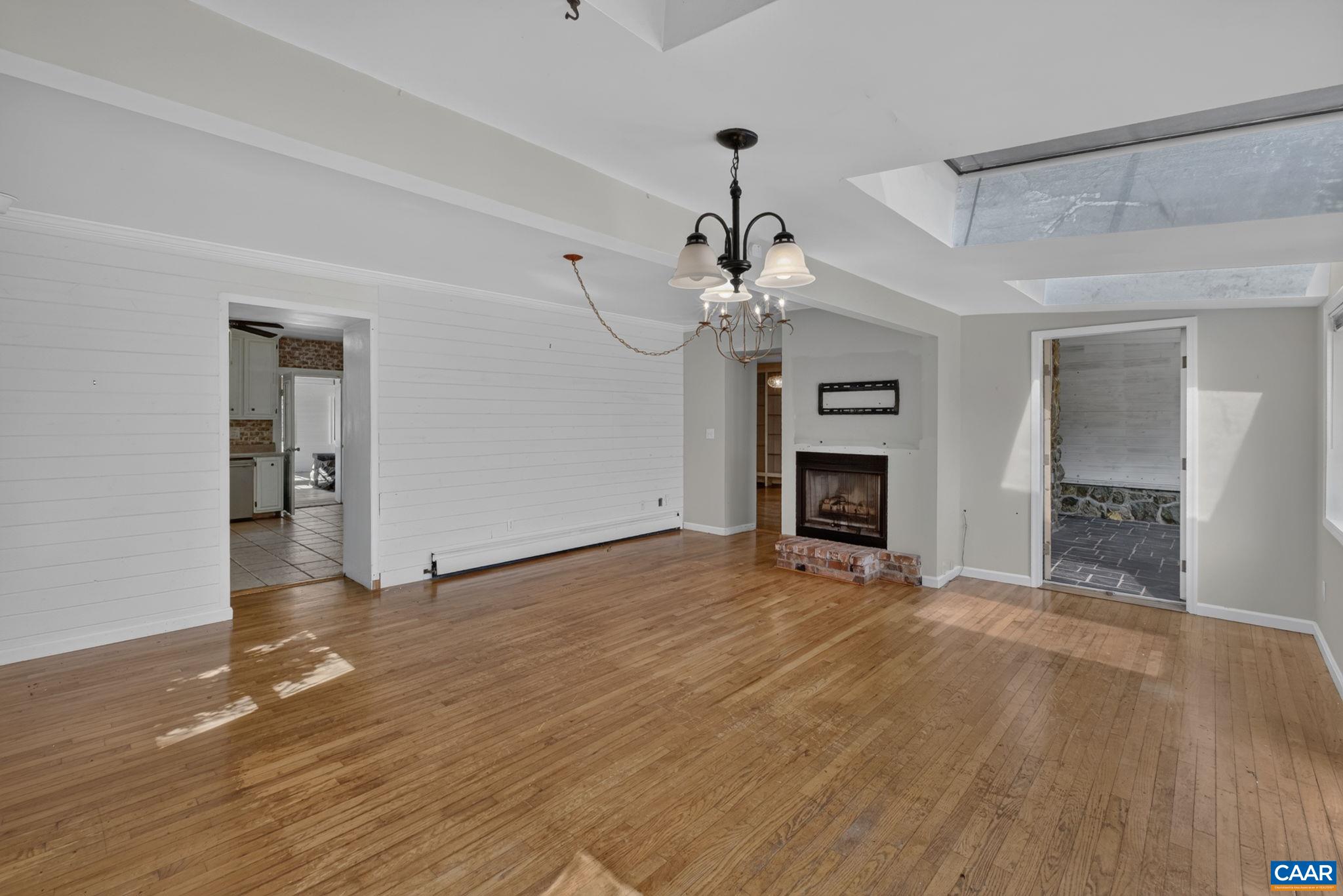 Family room with fireplace, door to the living room and back enclosed porch. Family room with fireplace, door to the living room and back enclosed porch.