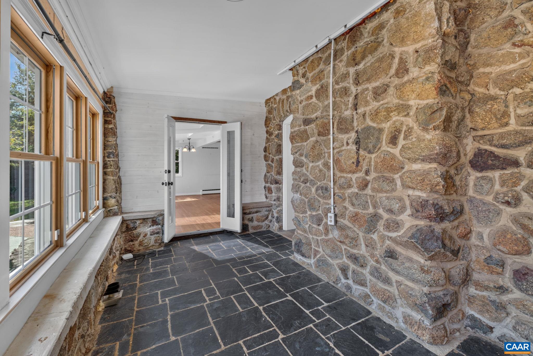 Enclosed back porch makes a wonderful hang out room or art studio. Enclosed back porch makes a wonderful hang out room or art studio.