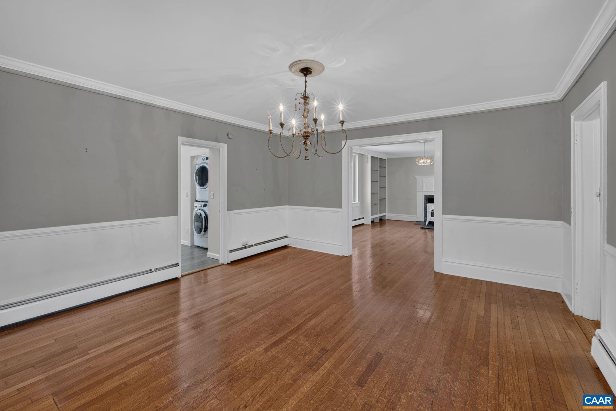 Dining room with door to main level en-suite bedroom. Dining room with door to main level en-suite bedroom.