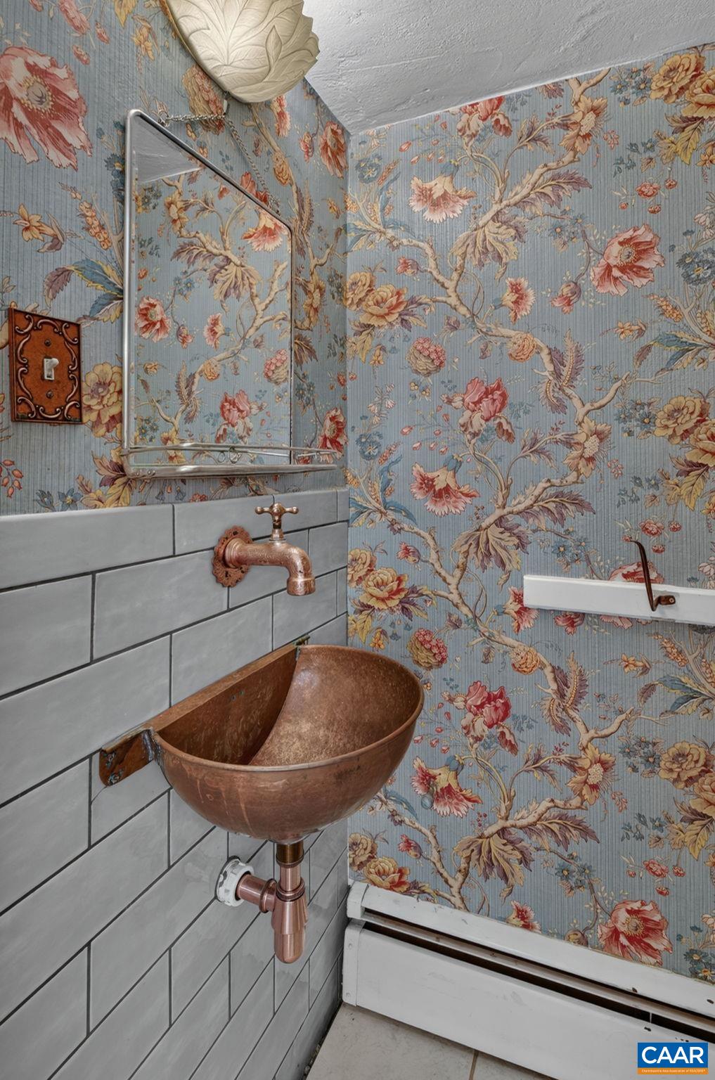Main level half bath with copper sink and piping. Main level half bath with copper sink and piping.