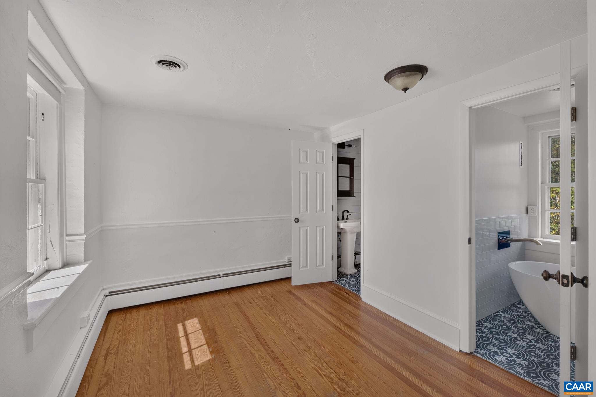 Upstairs primary bedroom with attached bath(s). Upstairs primary bedroom with attached bath(s).