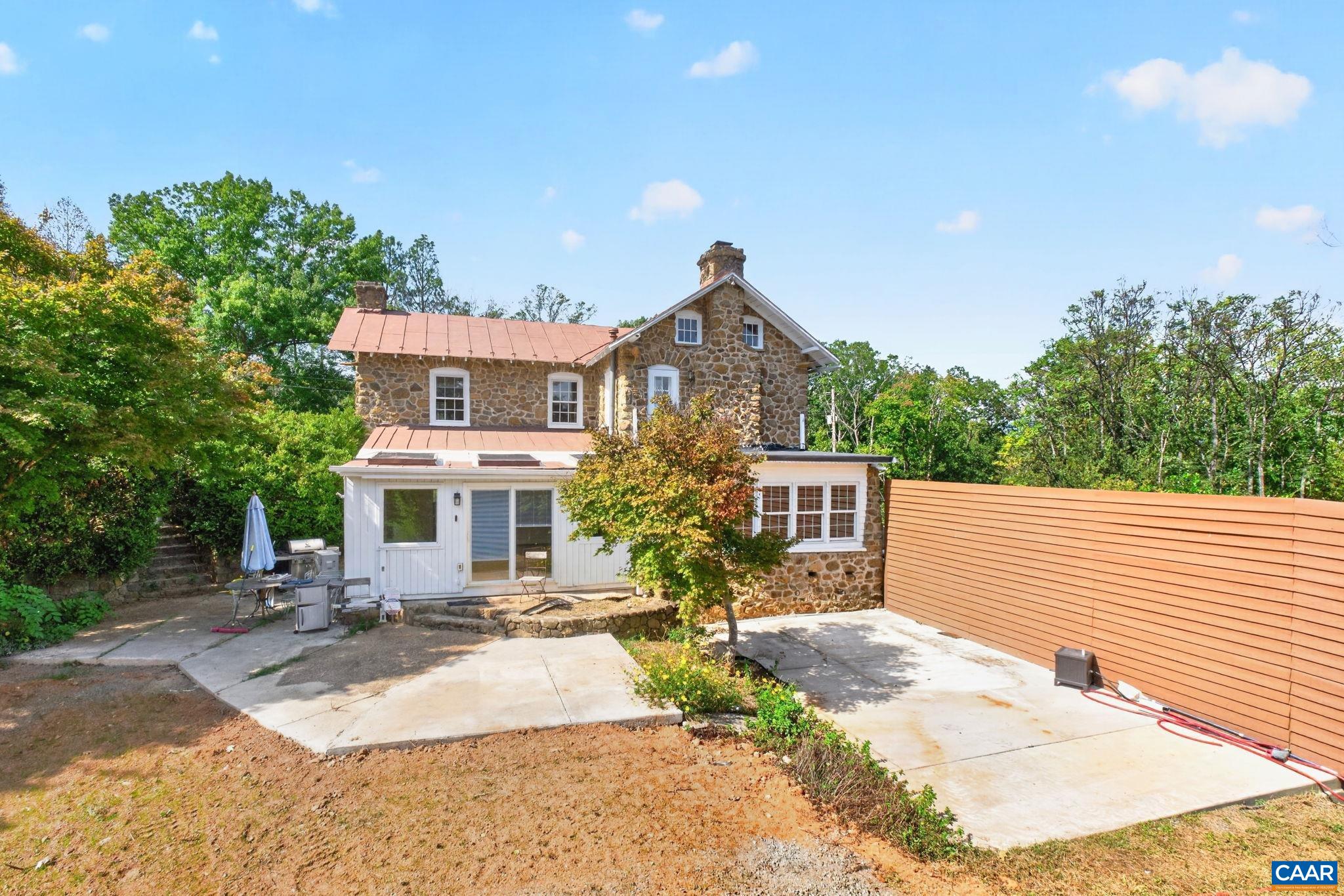 Rear of home with sunny patio areas. Rear of home with sunny patio areas.