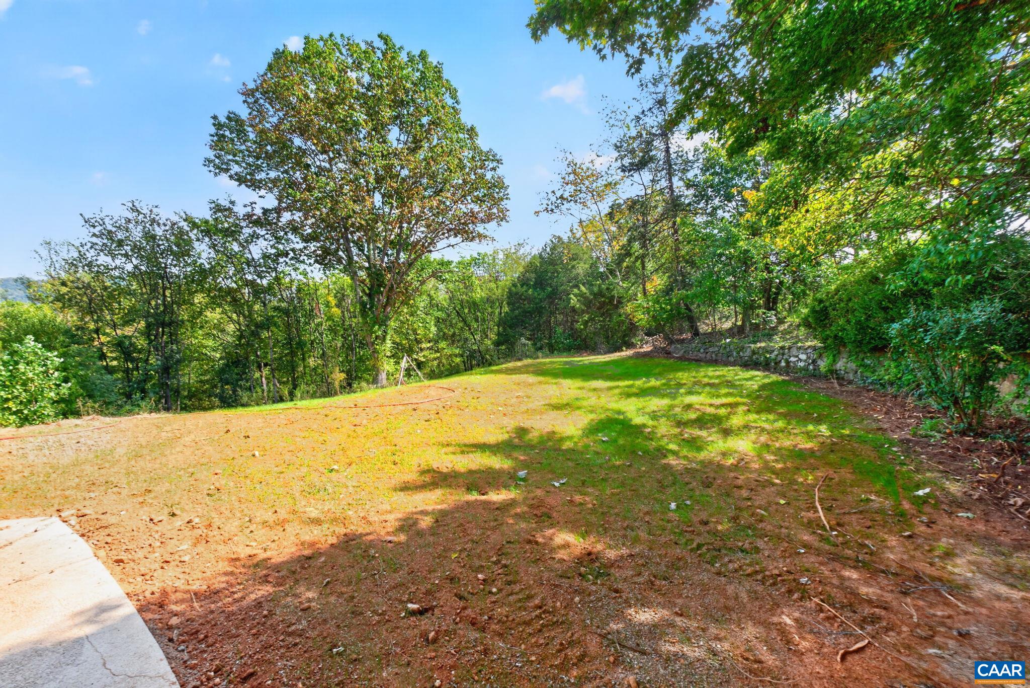 Just cleaned and graded backyard with stone wall. Just cleaned and graded backyard with stone wall.