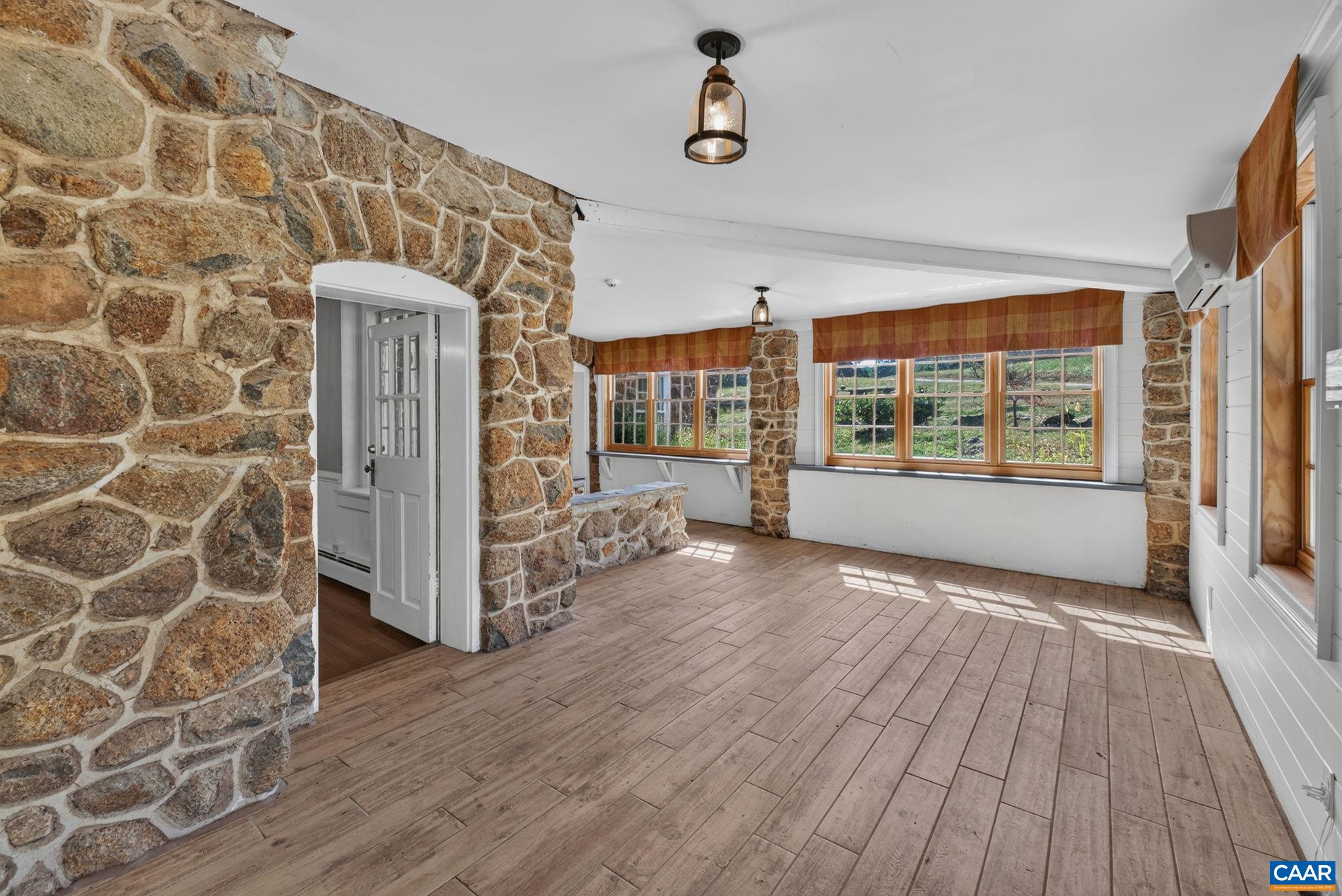 The enclosed front porch with ceramic tile flooring. The enclosed front porch with ceramic tile flooring.