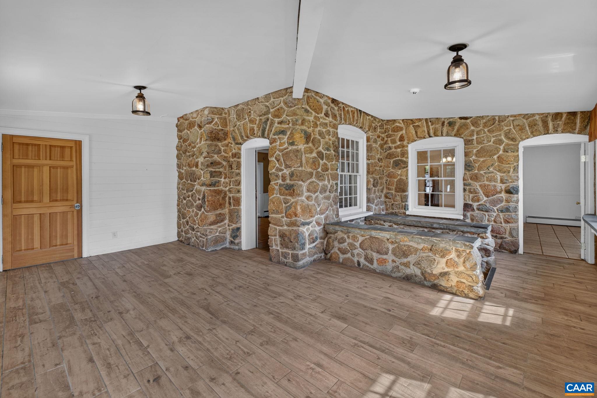 Front porch with doors to the dining room and kitchen. Front porch with doors to the dining room and kitchen.
