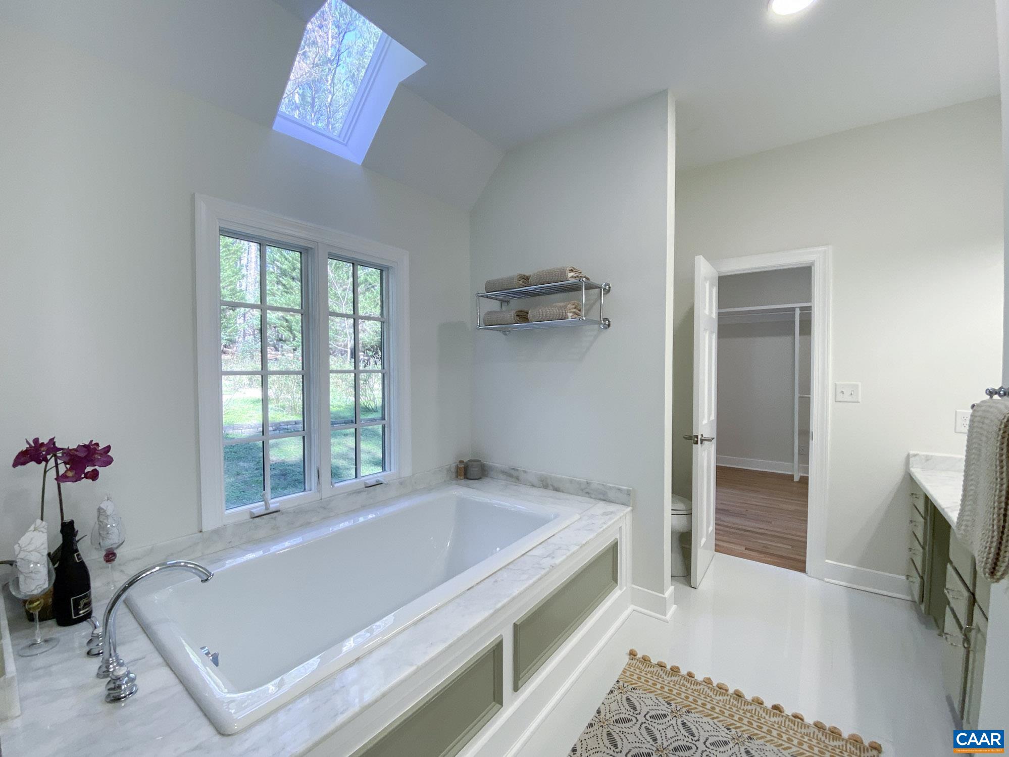 Dual sinks, deep soaking tub, stand alone shower. Garden views from tub!