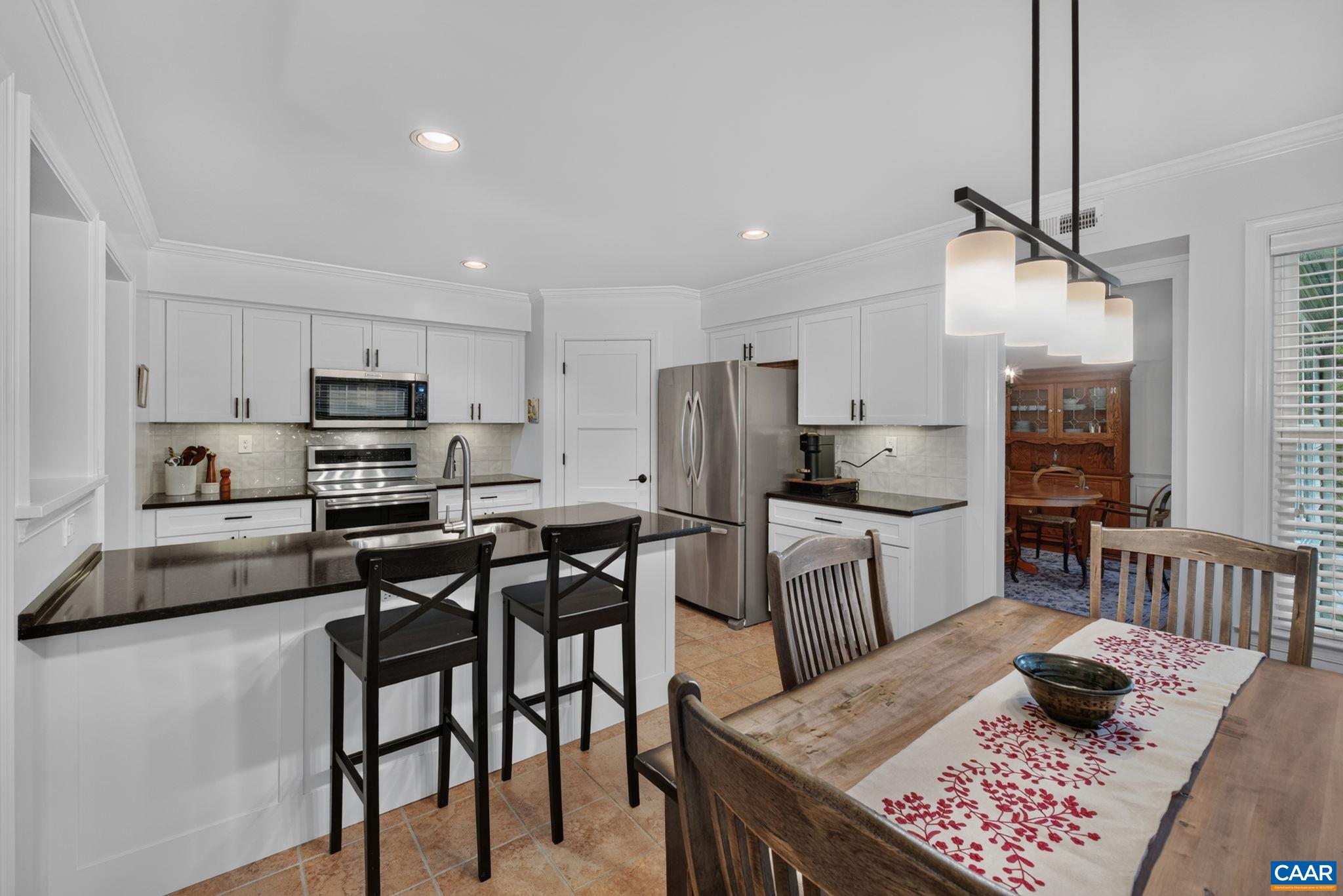 Island with counter overhang for stools.