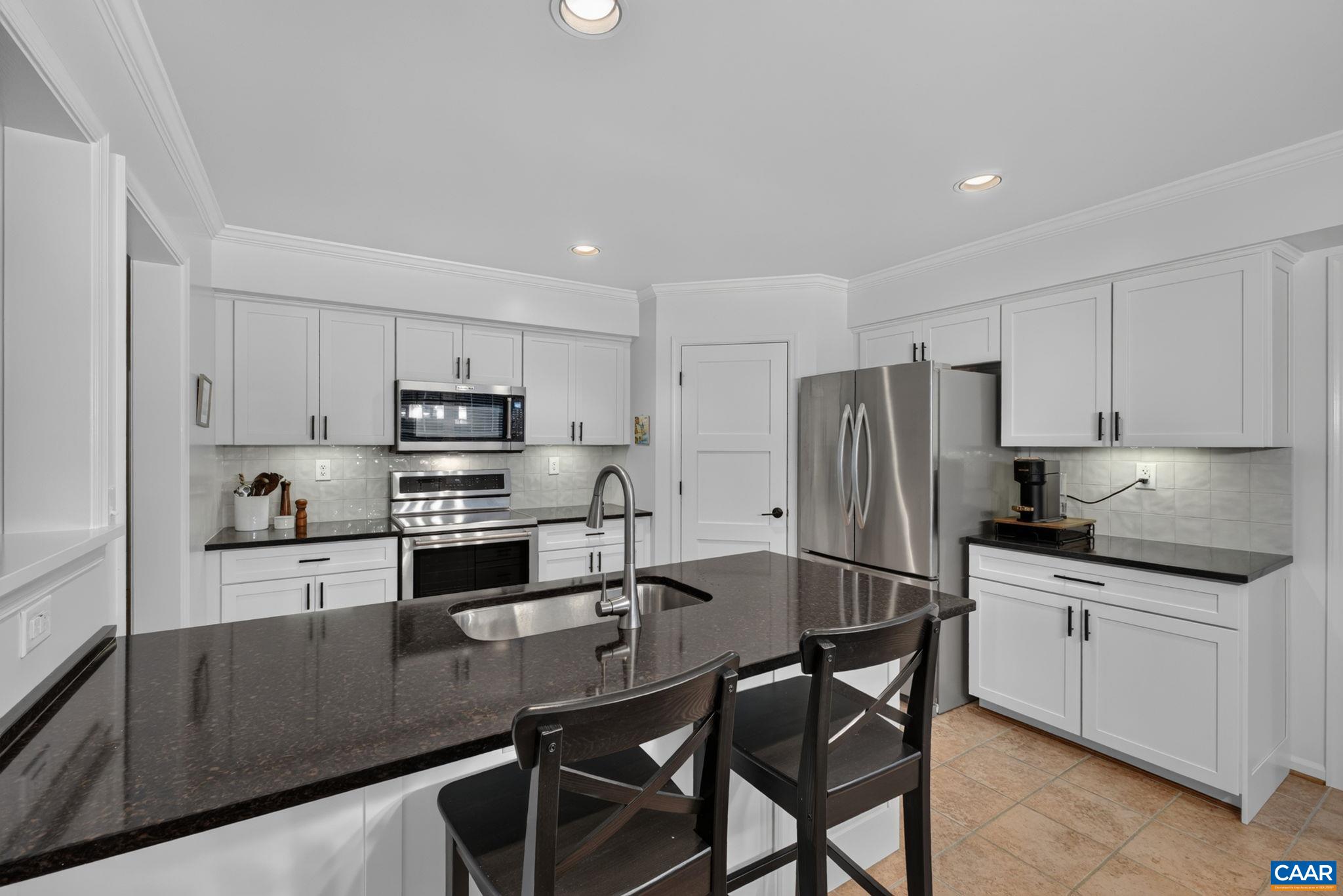 Recently refreshed kitchen with large pantry, quartz counters, and stainless appliances.
