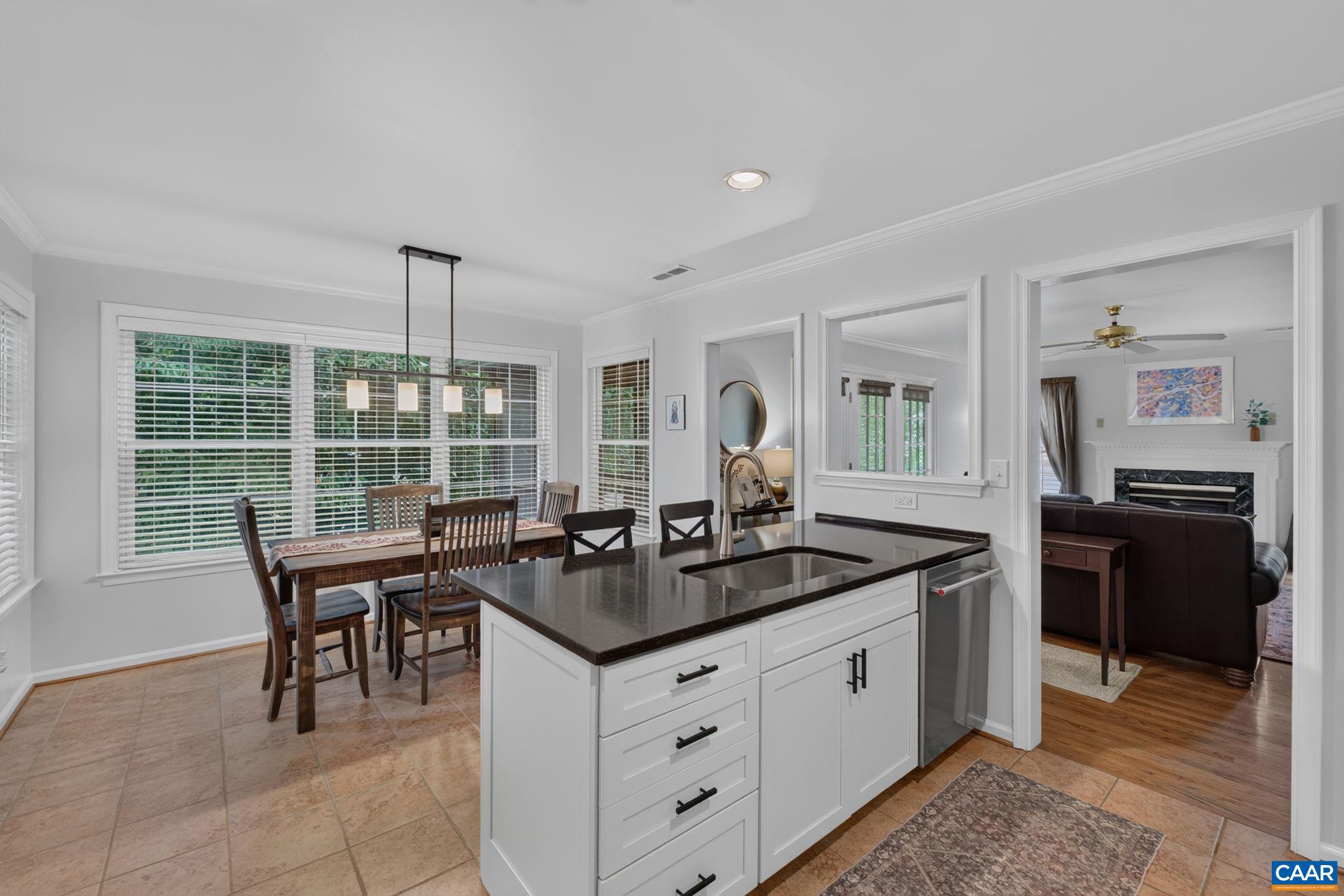 Kitchen island, kitchen eat-in spot and family room.
