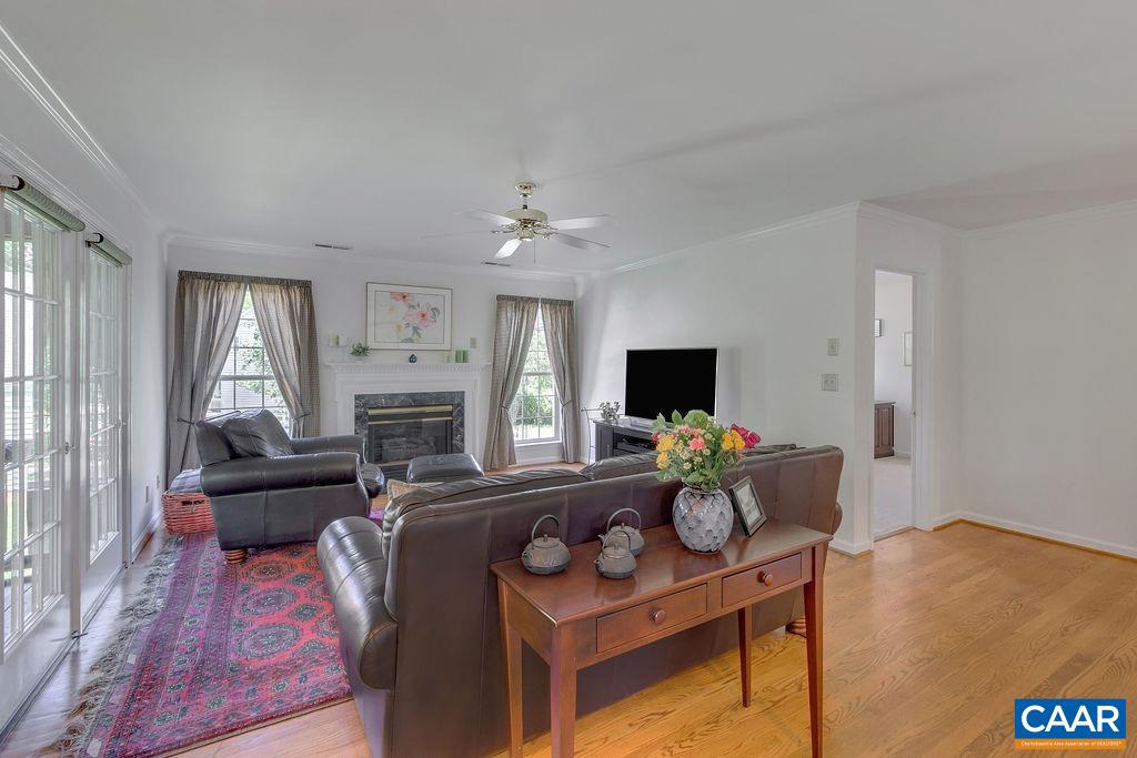 Family room off ktichen with fireplace and doors to the rear screen porch.