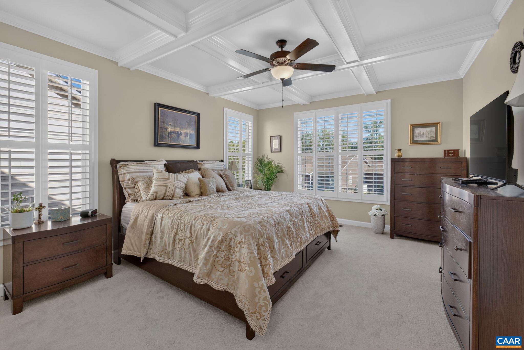 Primary bedroom with coffered ceiling and new carpet! Primary bedroom with coffered ceiling and new carpet!