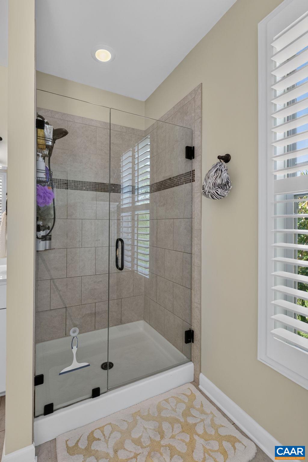 Shower with seamless glass door Shower with seamless glass door