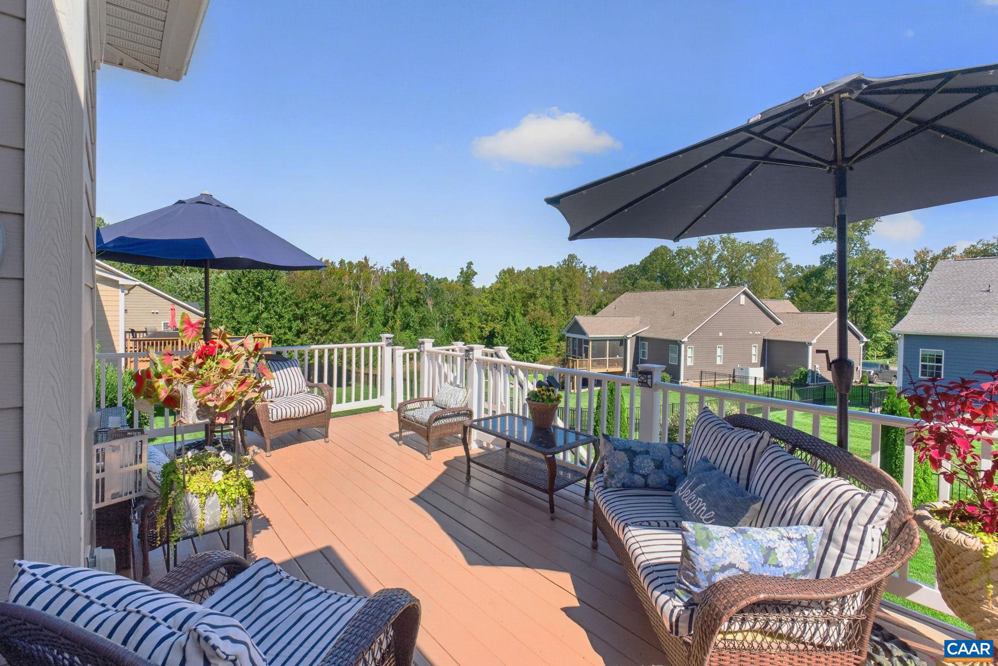 Back deck with access to great room, and stairs leading to lower terrace. Back deck with access to great room, and stairs leading to lower terrace.