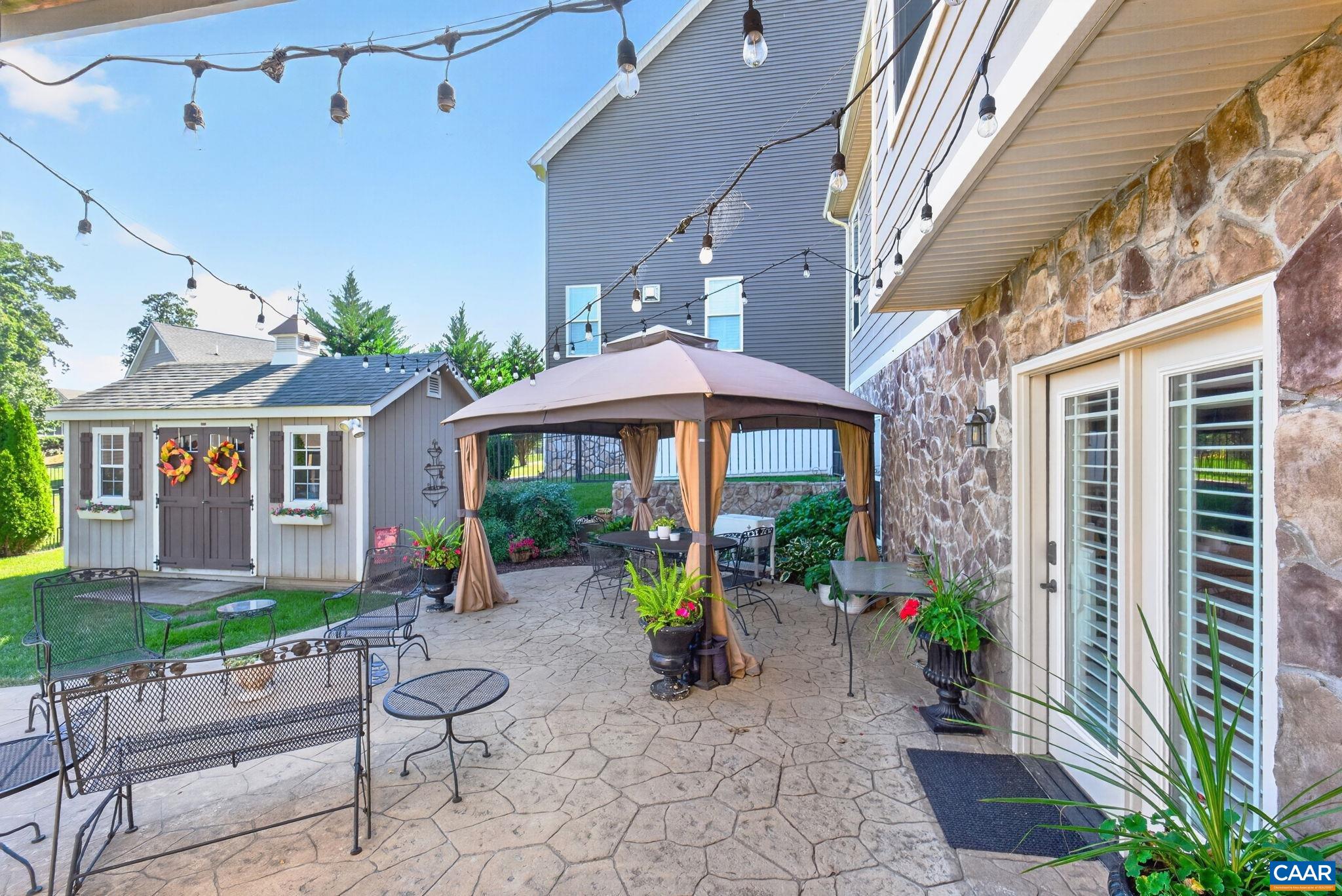 The large stamped-concrete patio is perfect for entertaining, and the fully fenced backyard is kid- and pet-friendly. The storage shed has electricity, and the gazebo is portable and negotiable for interested buyers. The large stamped-concrete patio is perfect for entertaining, and the fully fenced backyard is kid- and pet-friendly. The storage shed has electricity, and the gazebo is portable and negotiable for interested buyers.