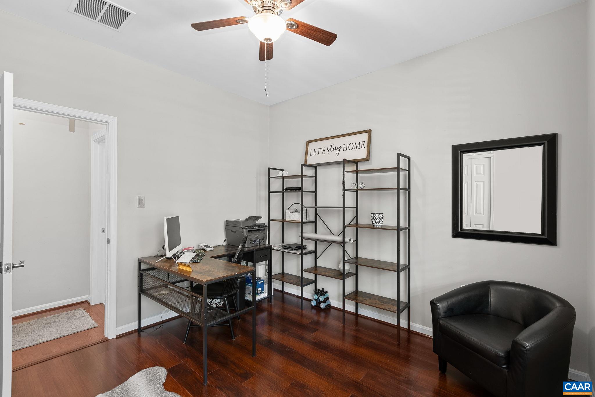 This main level 3rd bedroom is currently being used as an office. It has great natural light as seen thru the plantation shutters. This main level 3rd bedroom is currently being used as an office. It has great natural light as seen thru the plantation shutters.
