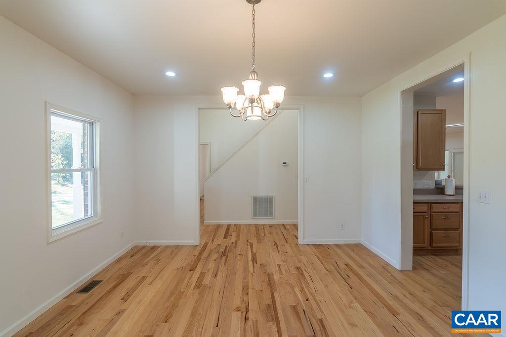 Dining room, located on the front of the home with access to the foyer and the kitchen.