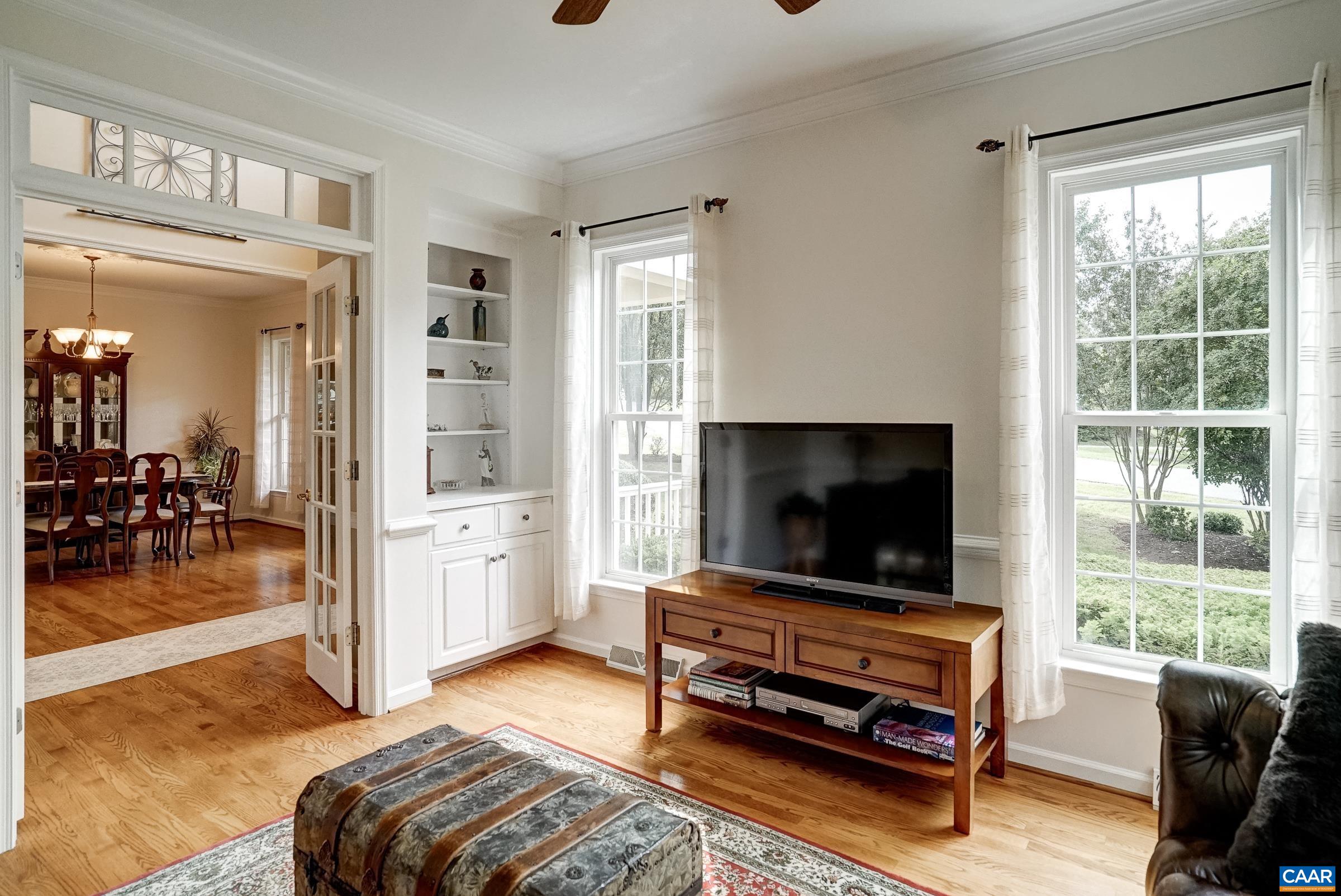 Den with french doors open to the foyer Den with french doors open to the foyer