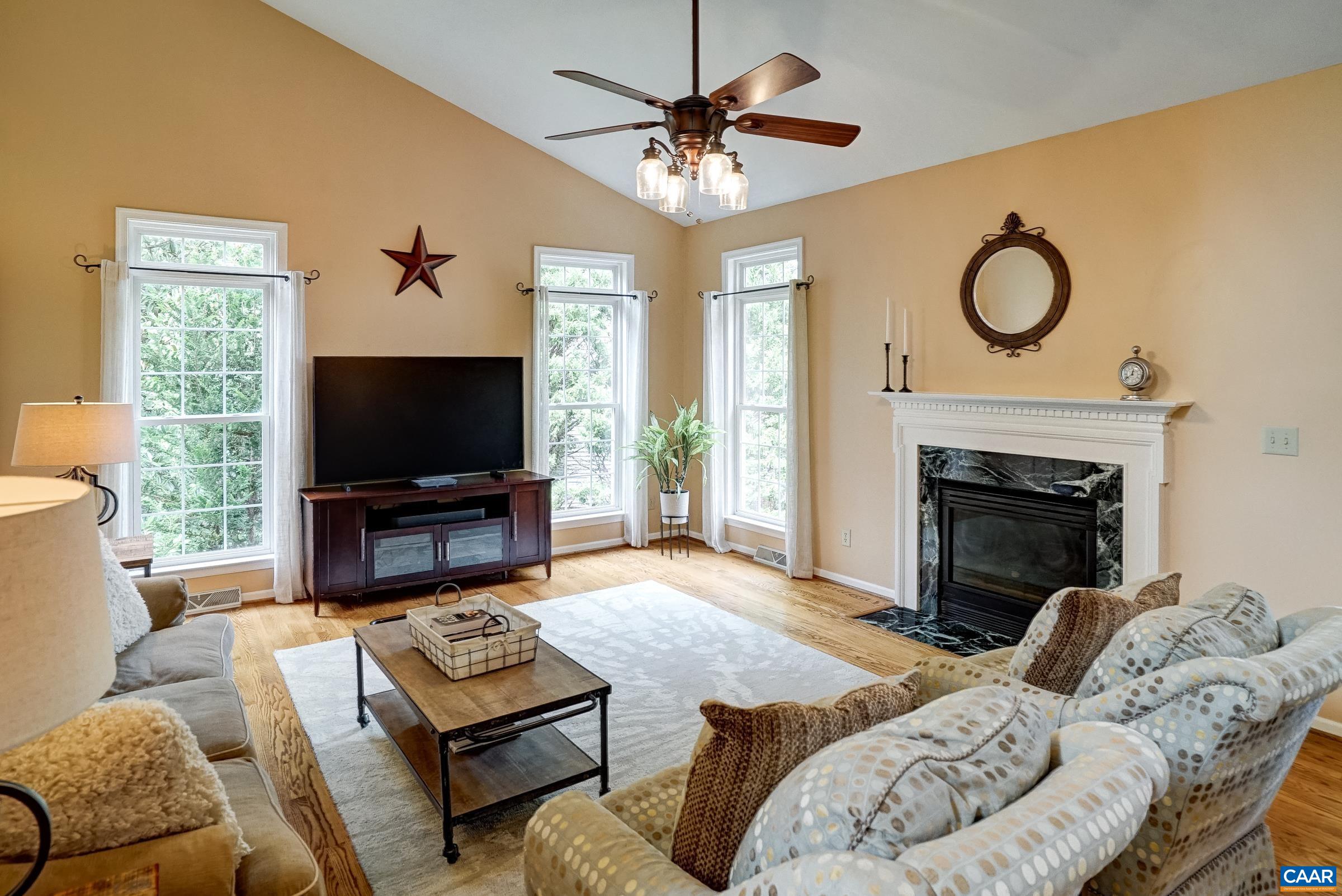 Vaulted great room with ceiling fan and gas fireplace. Vaulted great room with ceiling fan and gas fireplace.