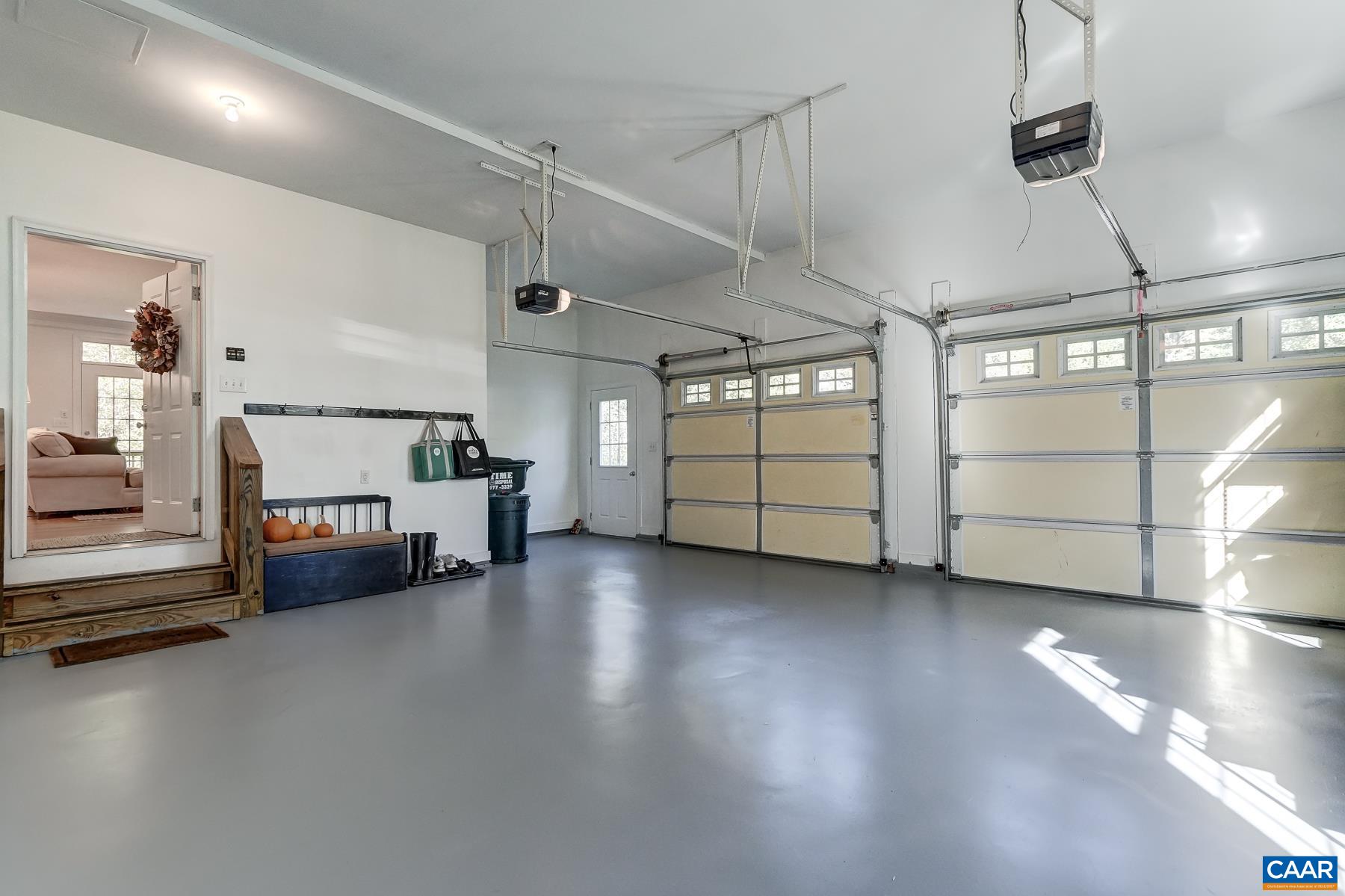 Oversized 2 car garage with extra storage space and painted flooring. Oversized 2 car garage with extra storage space and painted flooring.