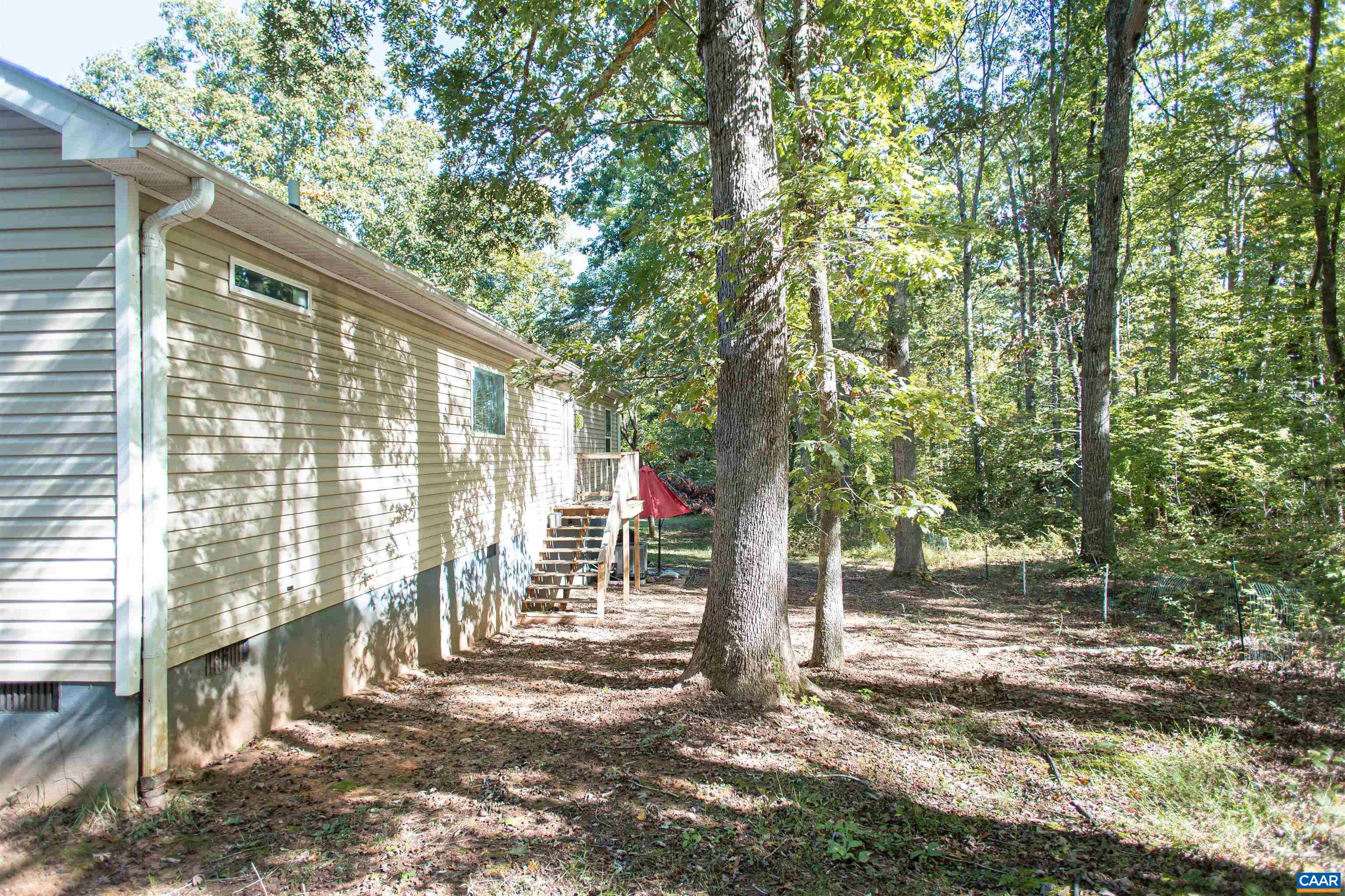 From the back of the home, access the crawl space with standing room for extra storage.