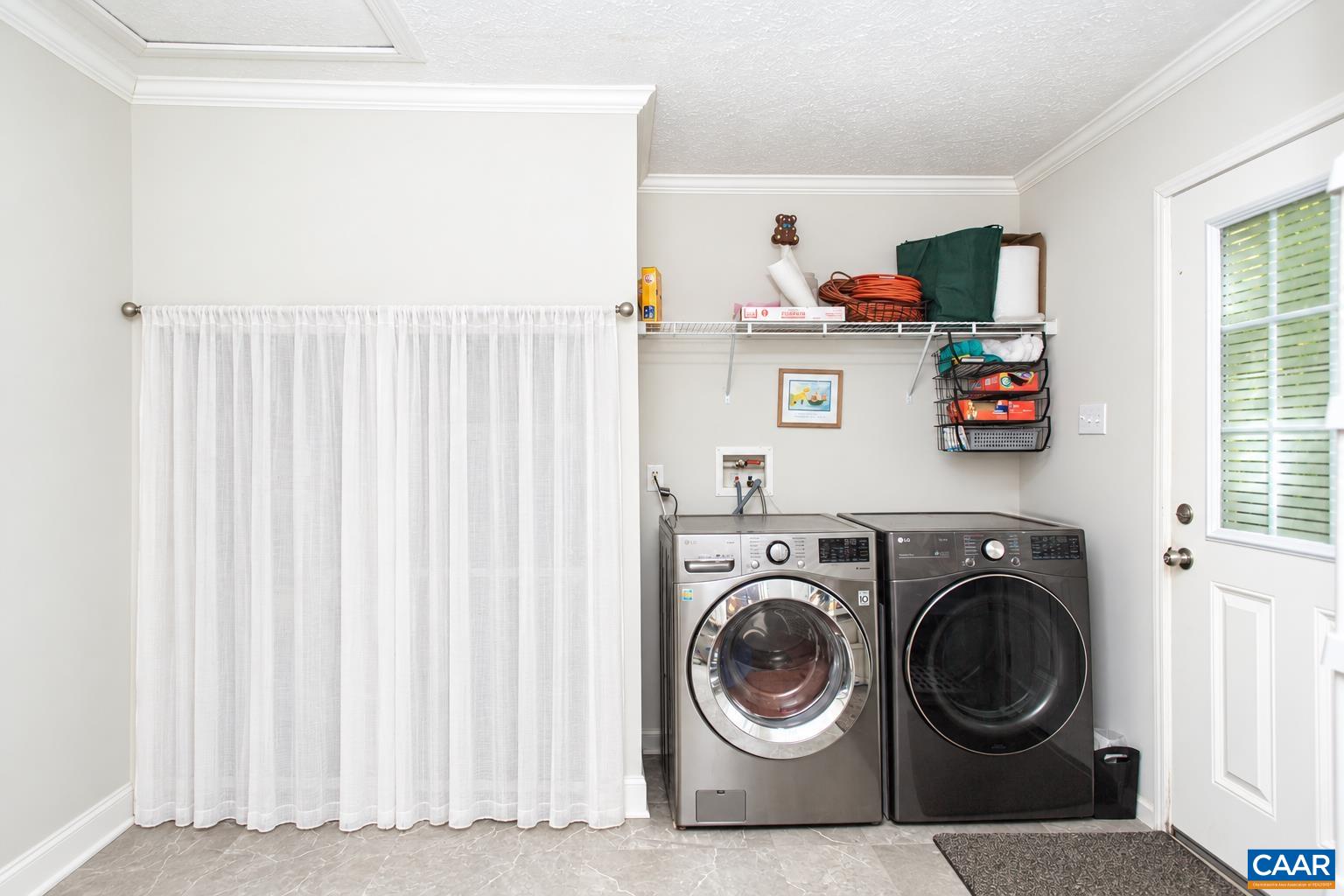 Laundry room/mud room with storage at the back of the house.