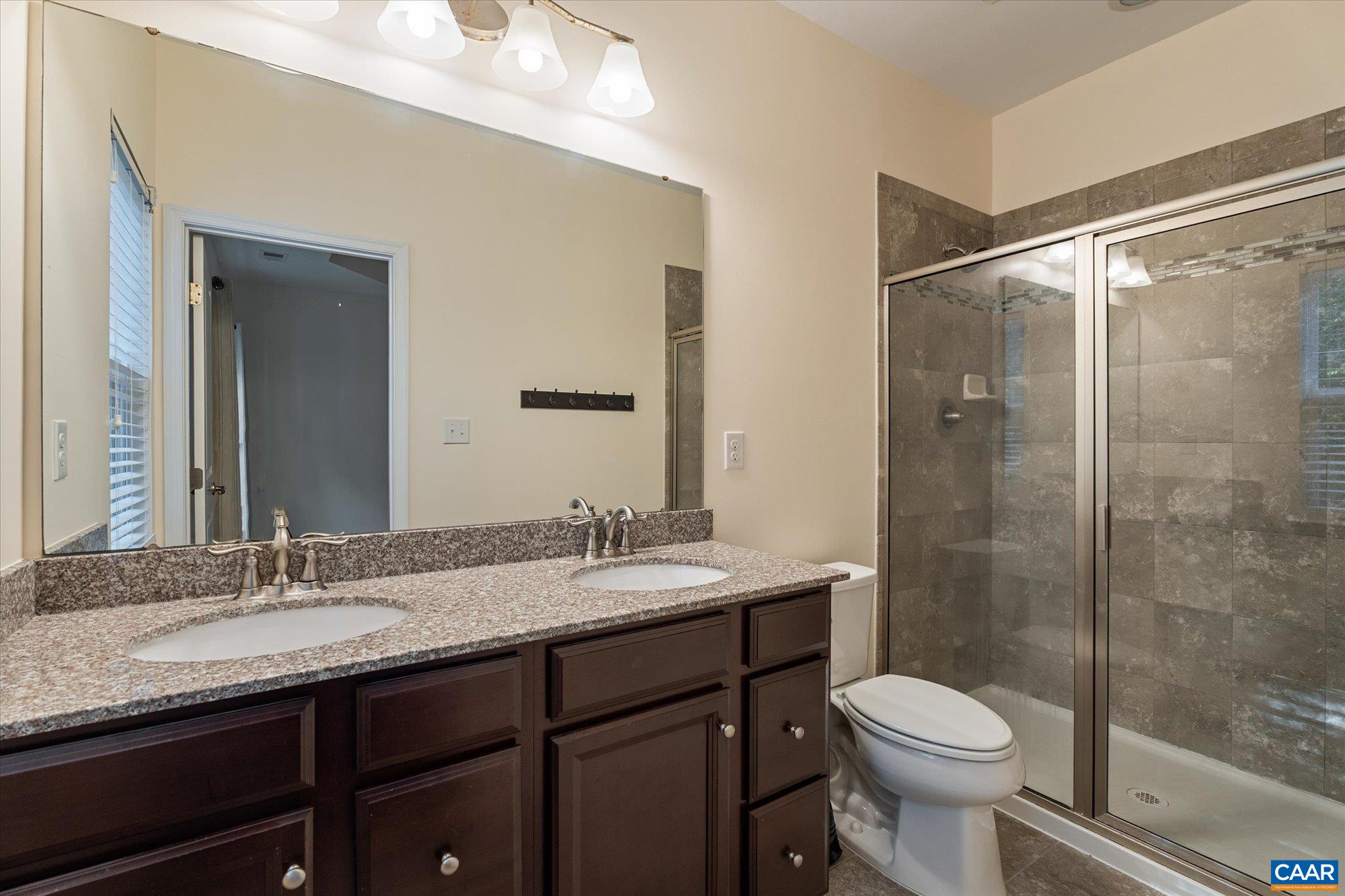 Dual vanities, walk-in shower with dual shower heads