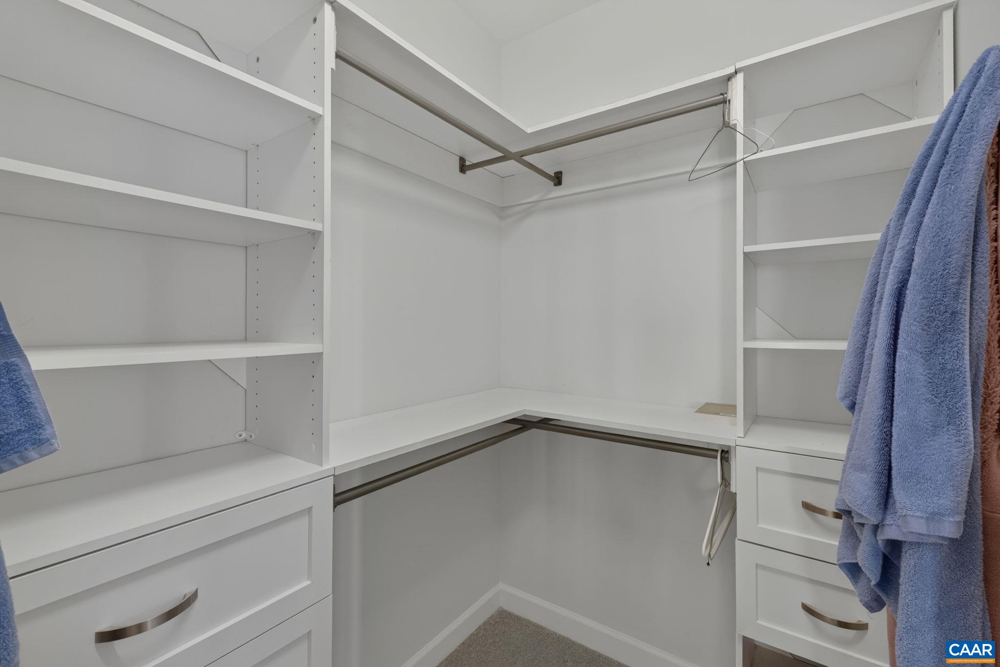 Customized walk-in closet. Attic access is from this closet and has flooring for additional storage, if desired. Customized walk-in closet. Attic access is from this closet and has flooring for additional storage, if desired.