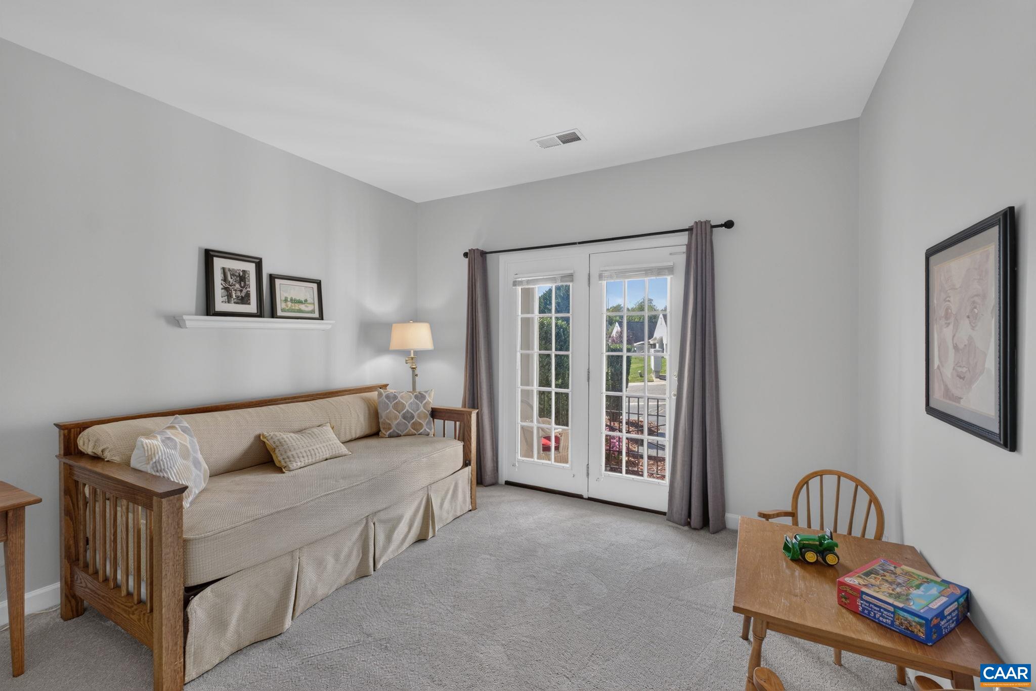 Secondary bedroom on the main level can also be great as a home office, library, or even home gym. Doors open to the covered exterior patio. Secondary bedroom on the main level can also be great as a home office, library, or even home gym. Doors open to the covered exterior patio.