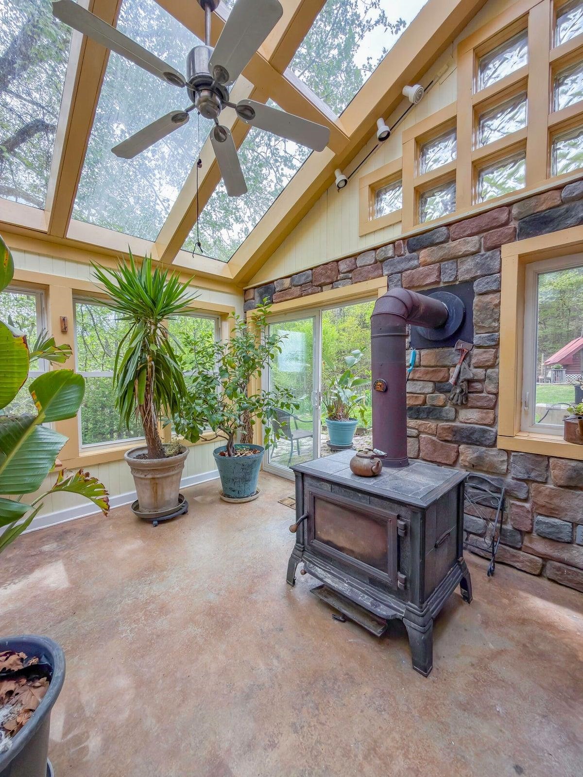 Attached greenhouse with wood stove Attached greenhouse with wood stove
