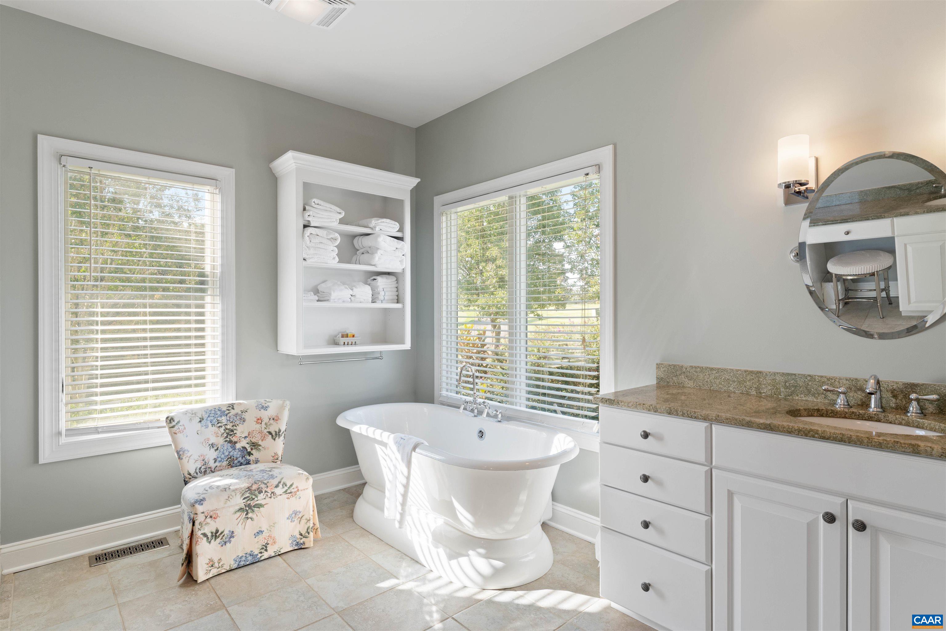 Primary bath with freestanding soaking tub, granite vanity and separate shower. Built-in closet systems in both primary closets. Primary bath with freestanding soaking tub, granite vanity and separate shower. Built-in closet systems in both primary closets.