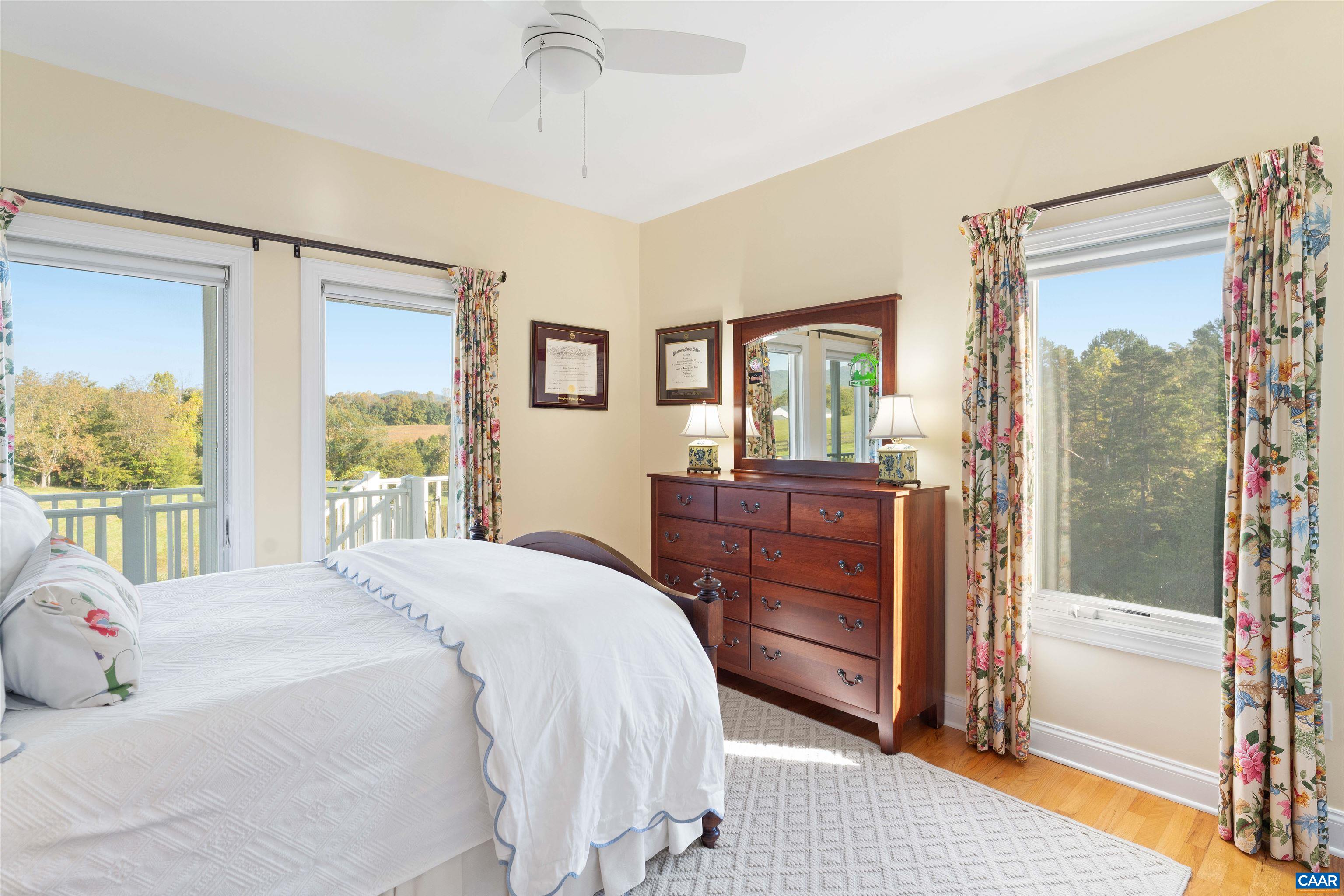 Bedroom with windows on two sides and views across the pasture. Bedroom with windows on two sides and views across the pasture.