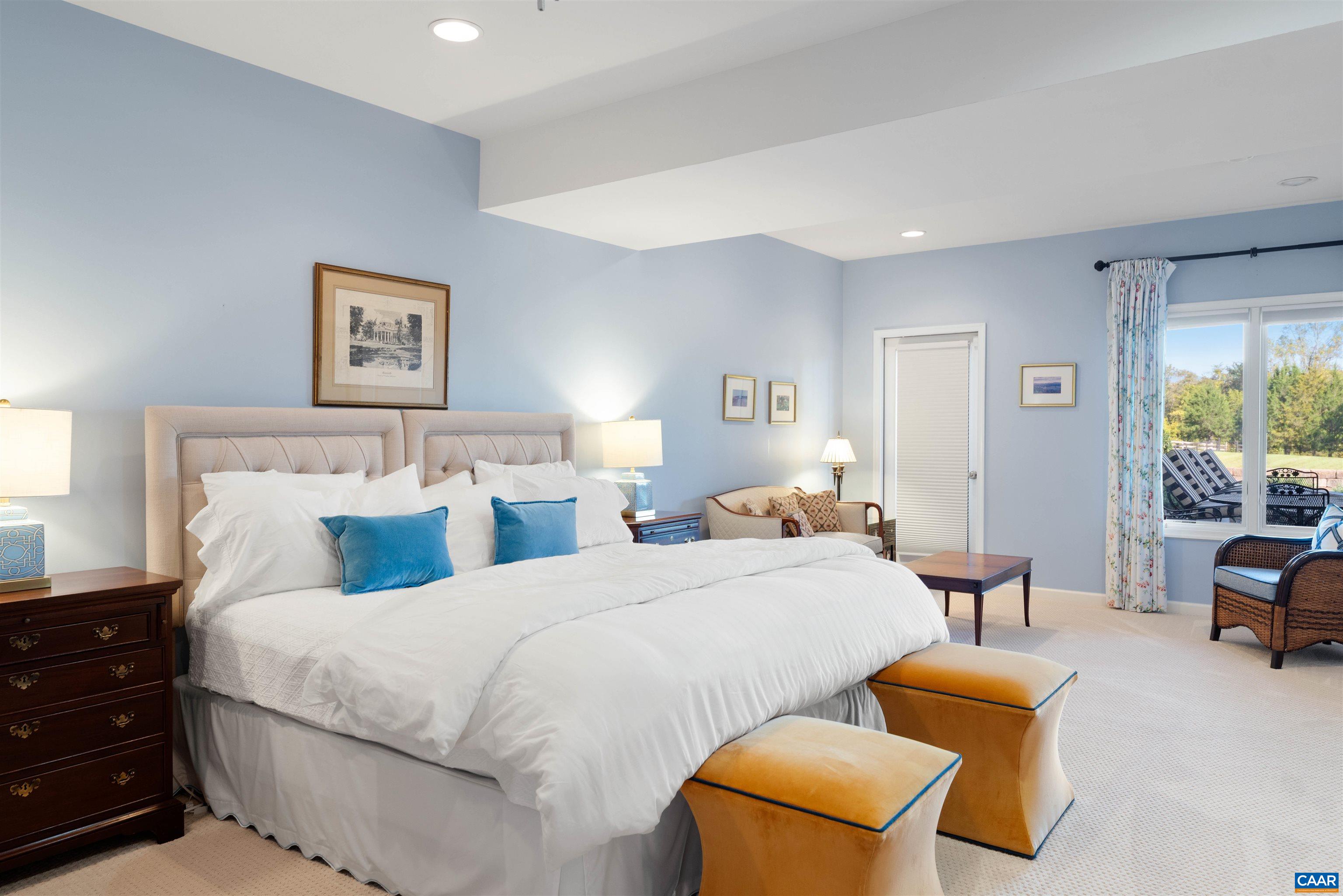 Lower level bedroom with natural light and a sitting area. Lower level bedroom with natural light and a sitting area.