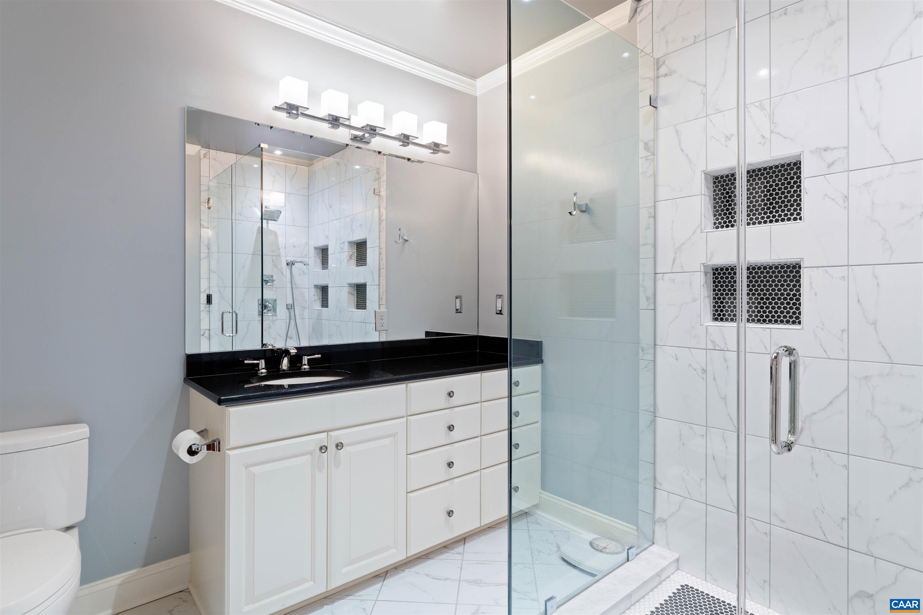 Lower level bath renovated in 2021: frameless glass shower, new tile and fixtures throughout. Lower level bath renovated in 2021: frameless glass shower, new tile and fixtures throughout.
