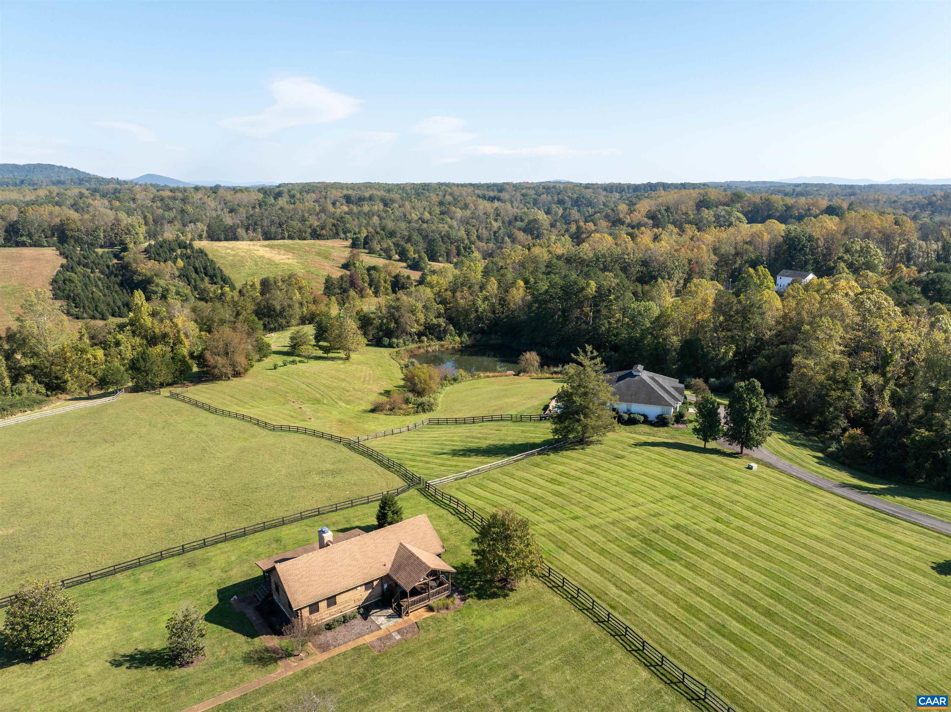 The log cabin from above, surrounded by board-fenced paddocks. The log cabin from above, surrounded by board-fenced paddocks.