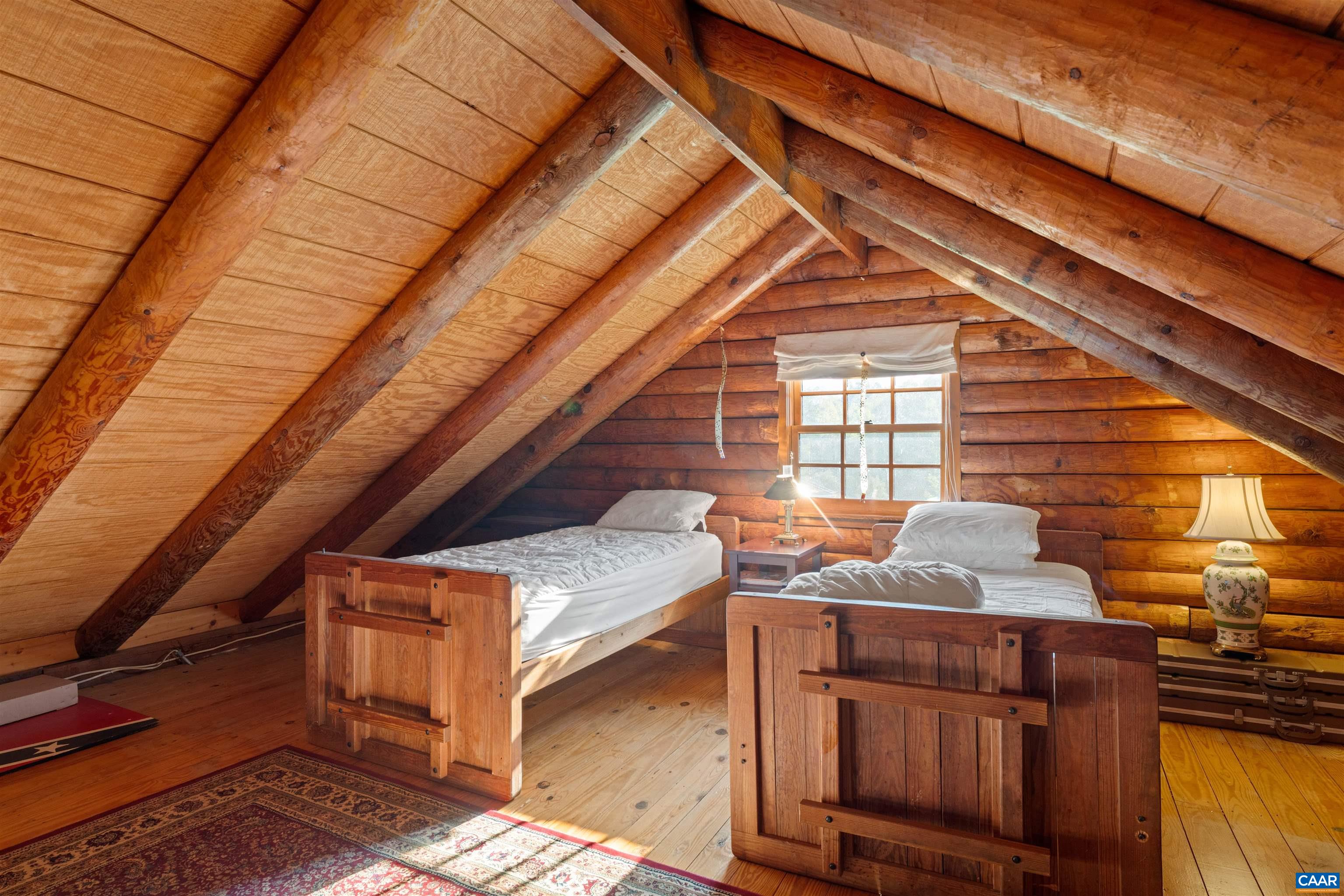 Cabin loft under the roof timbers, set up as a bunk room. Cabin loft under the roof timbers, set up as a bunk room.