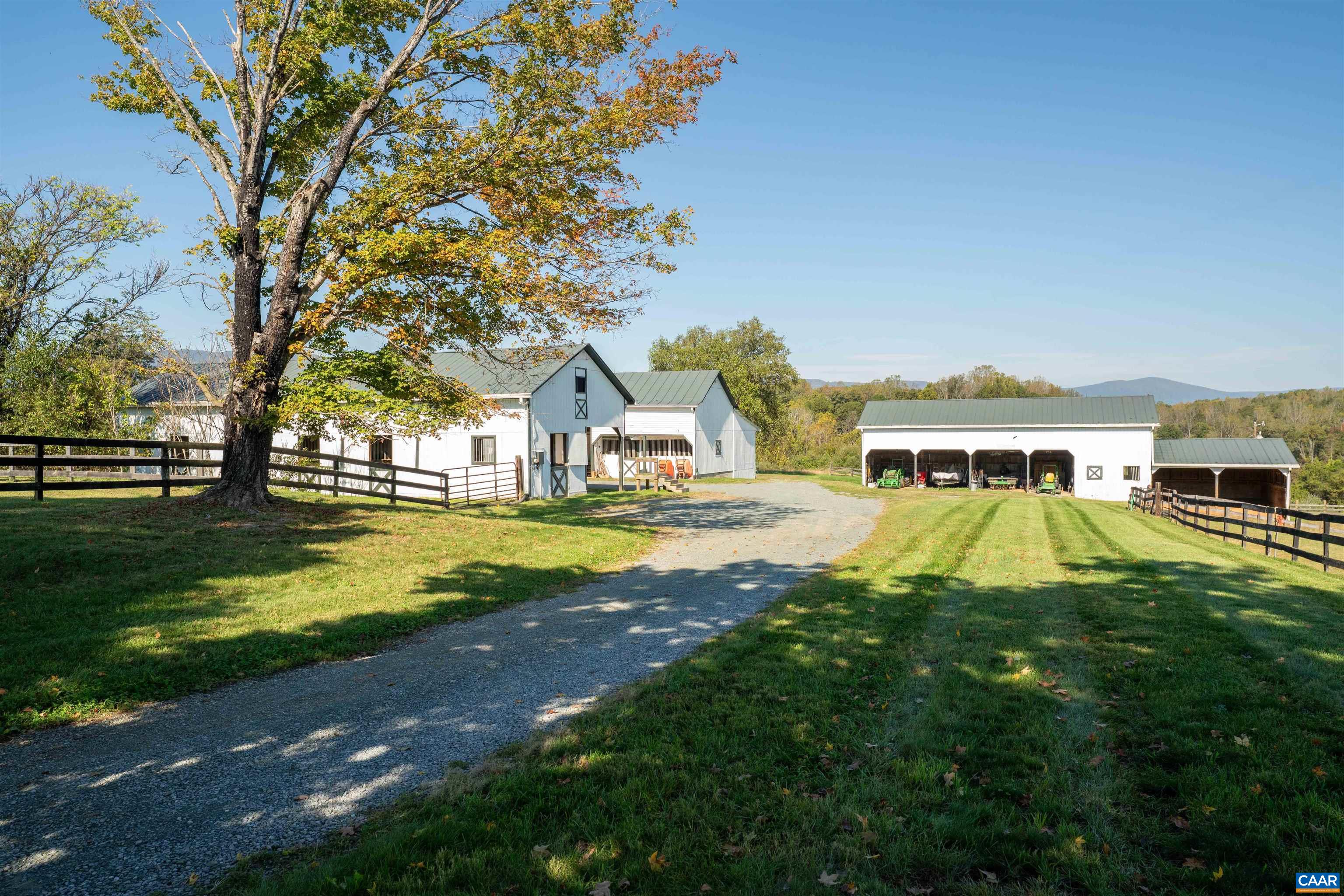 The barns from the drive, with fenced paddocks on both sides. The barns from the drive, with fenced paddocks on both sides.