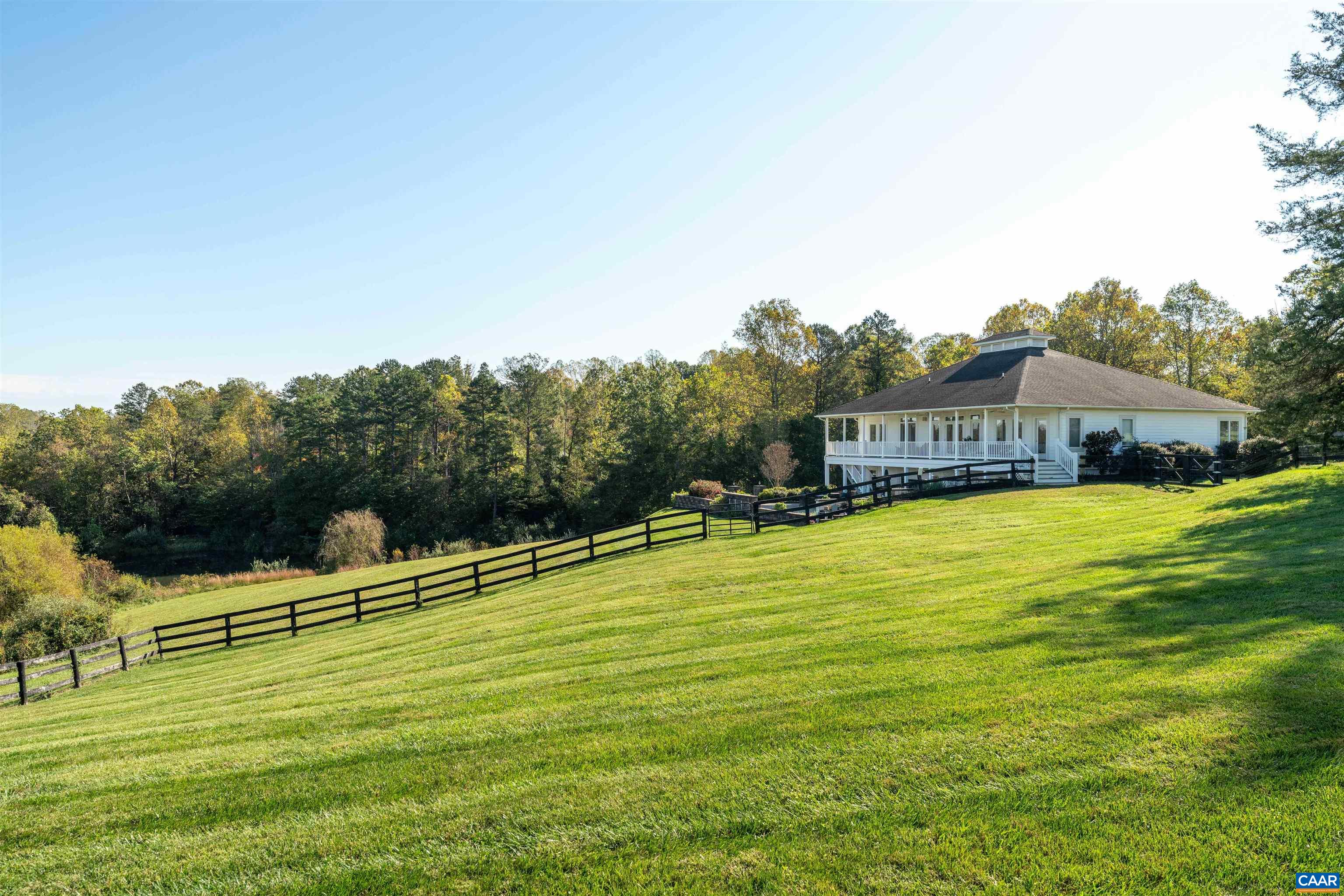 The residence above the board-fenced pasture. The residence above the board-fenced pasture.