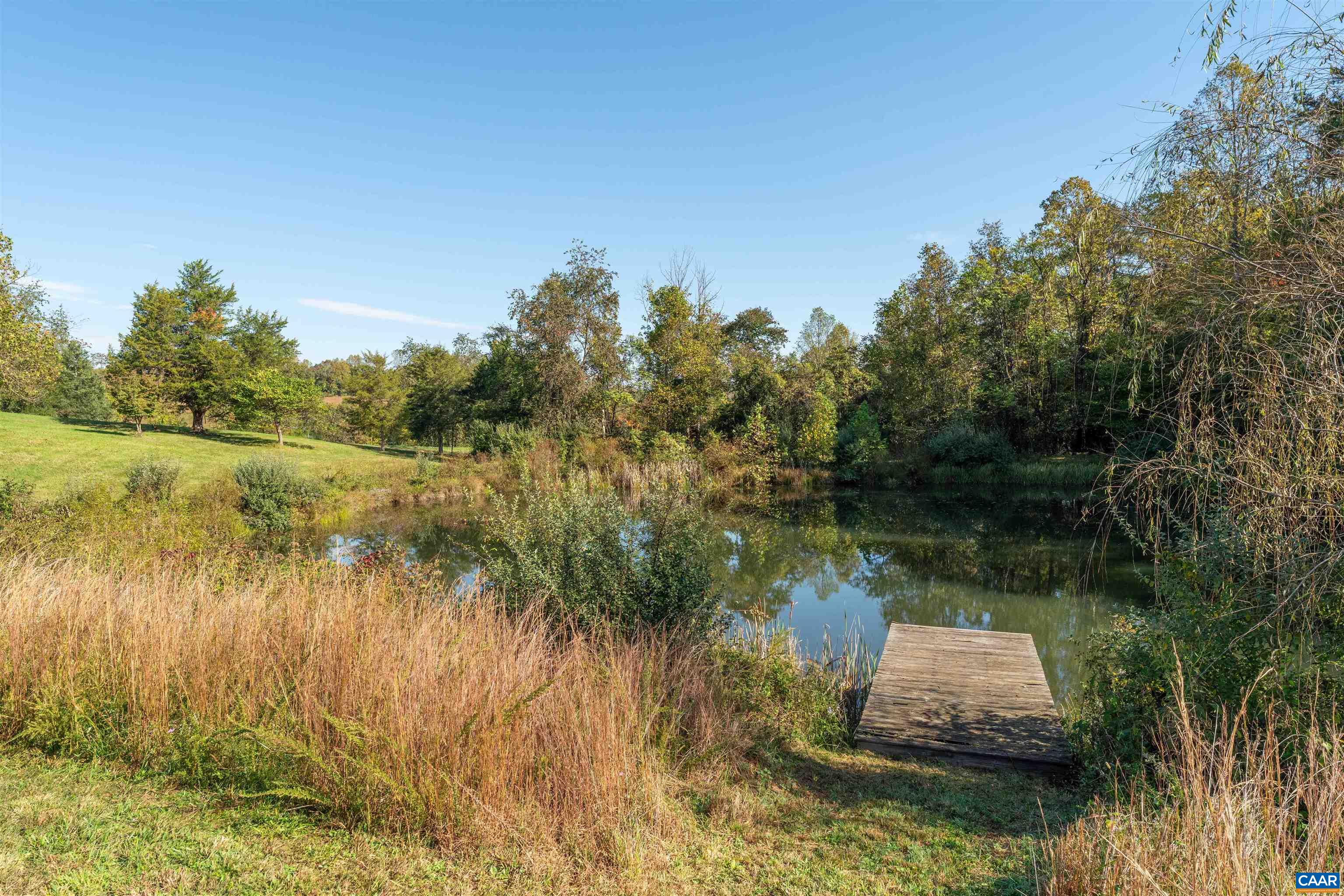 Meadow down to the pond, which is stocked and has a dock with power and an aeration system. Meadow down to the pond, which is stocked and has a dock with power and an aeration system.