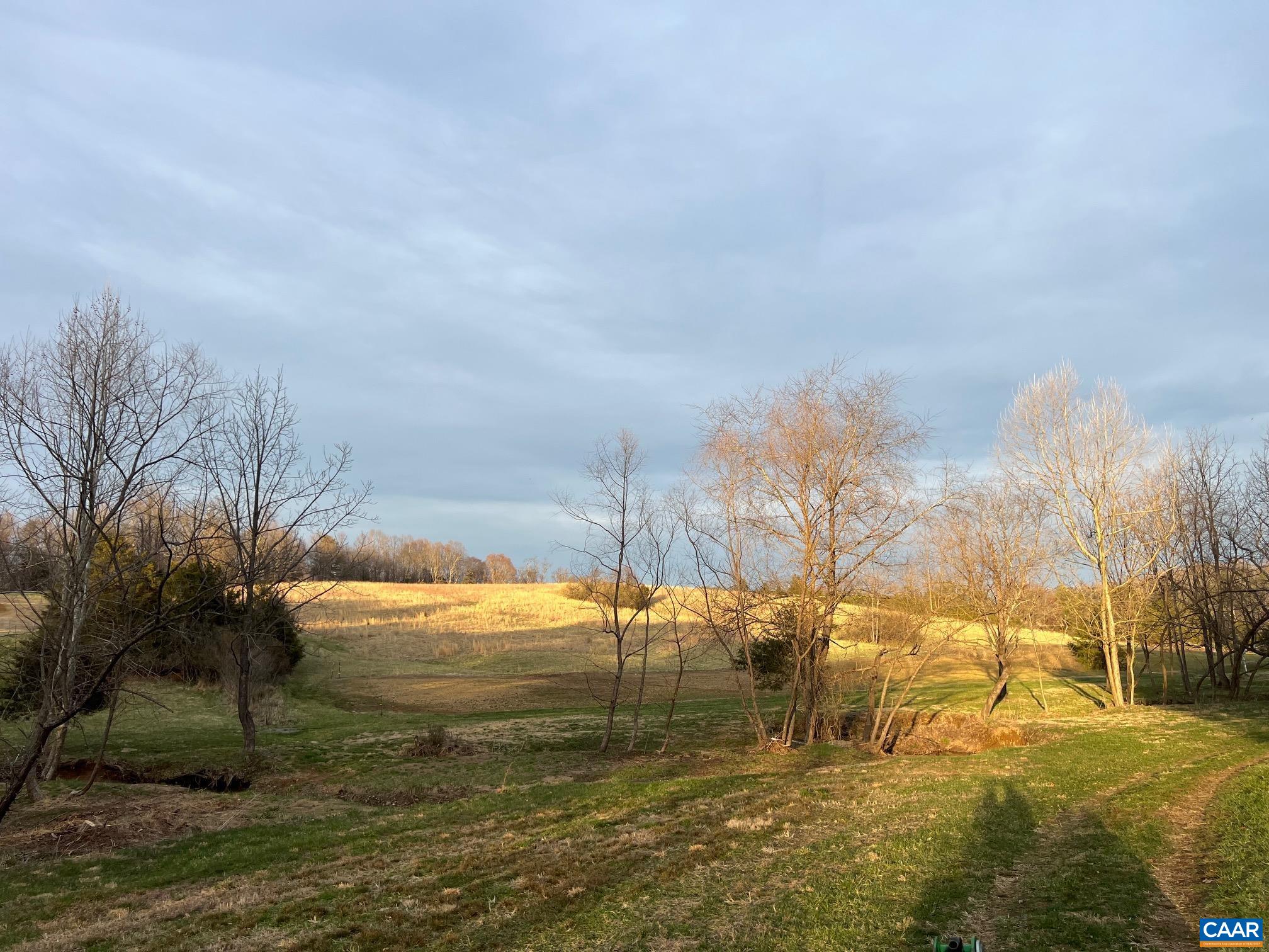 The fields in winter, with the hardwoods bare and the long views open across the property. The fields in winter, with the hardwoods bare and the long views open across the property.