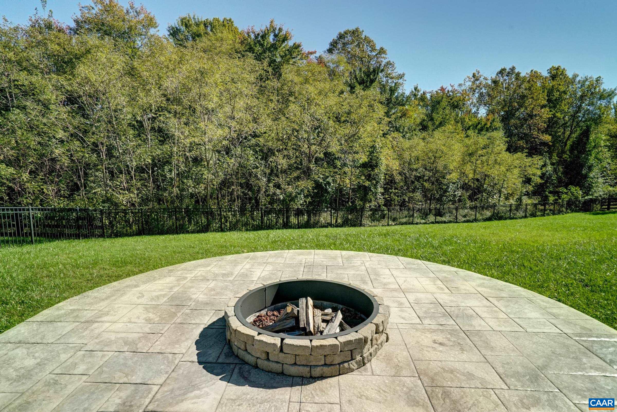 Gather at the firepit for marshmallows and stargazing. Half acre yard backs to community trails! Gather at the firepit for marshmallows and stargazing. Half acre yard backs to community trails!