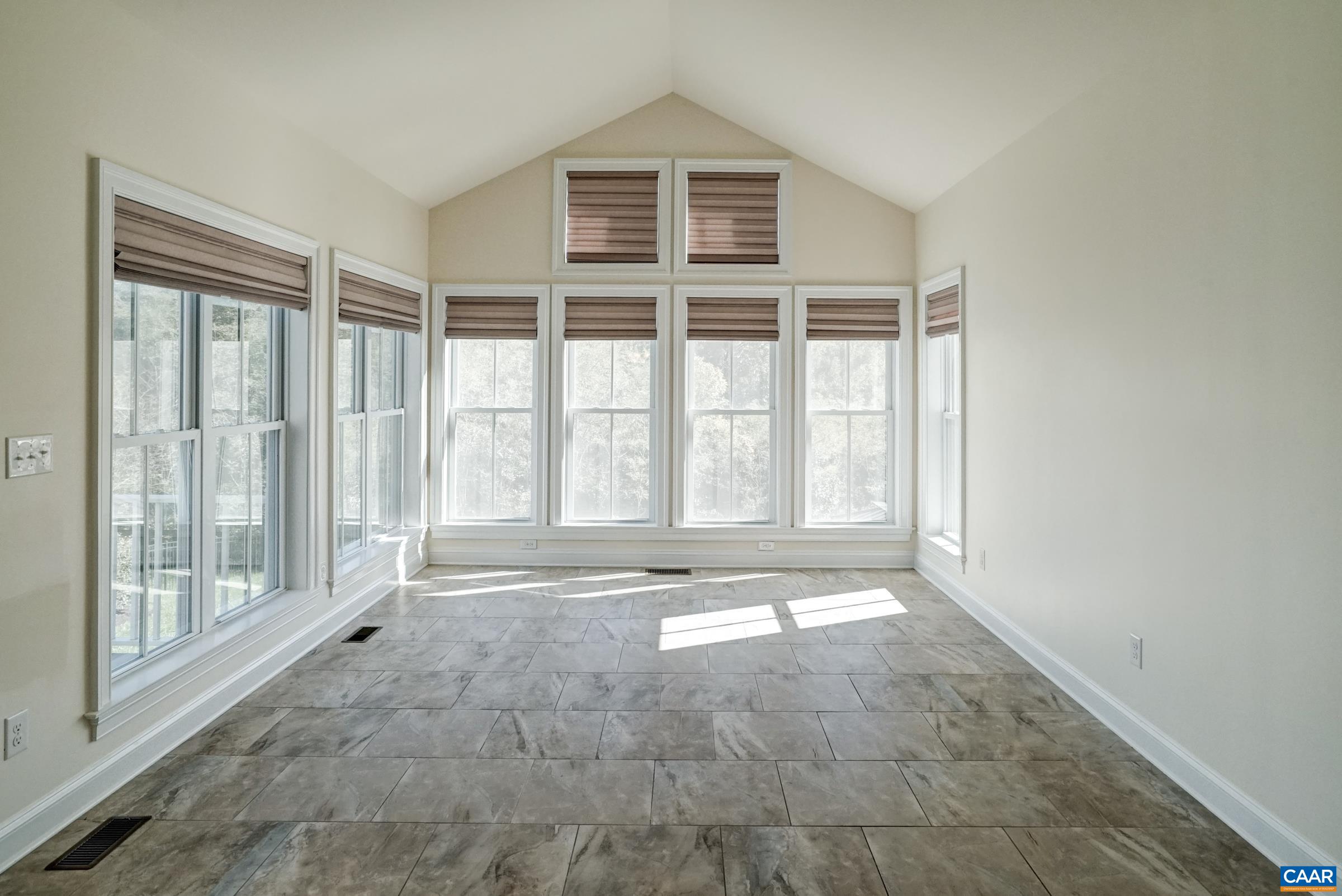 Stunning sunroom with Hunter-Douglas shades. Stunning sunroom with Hunter-Douglas shades.
