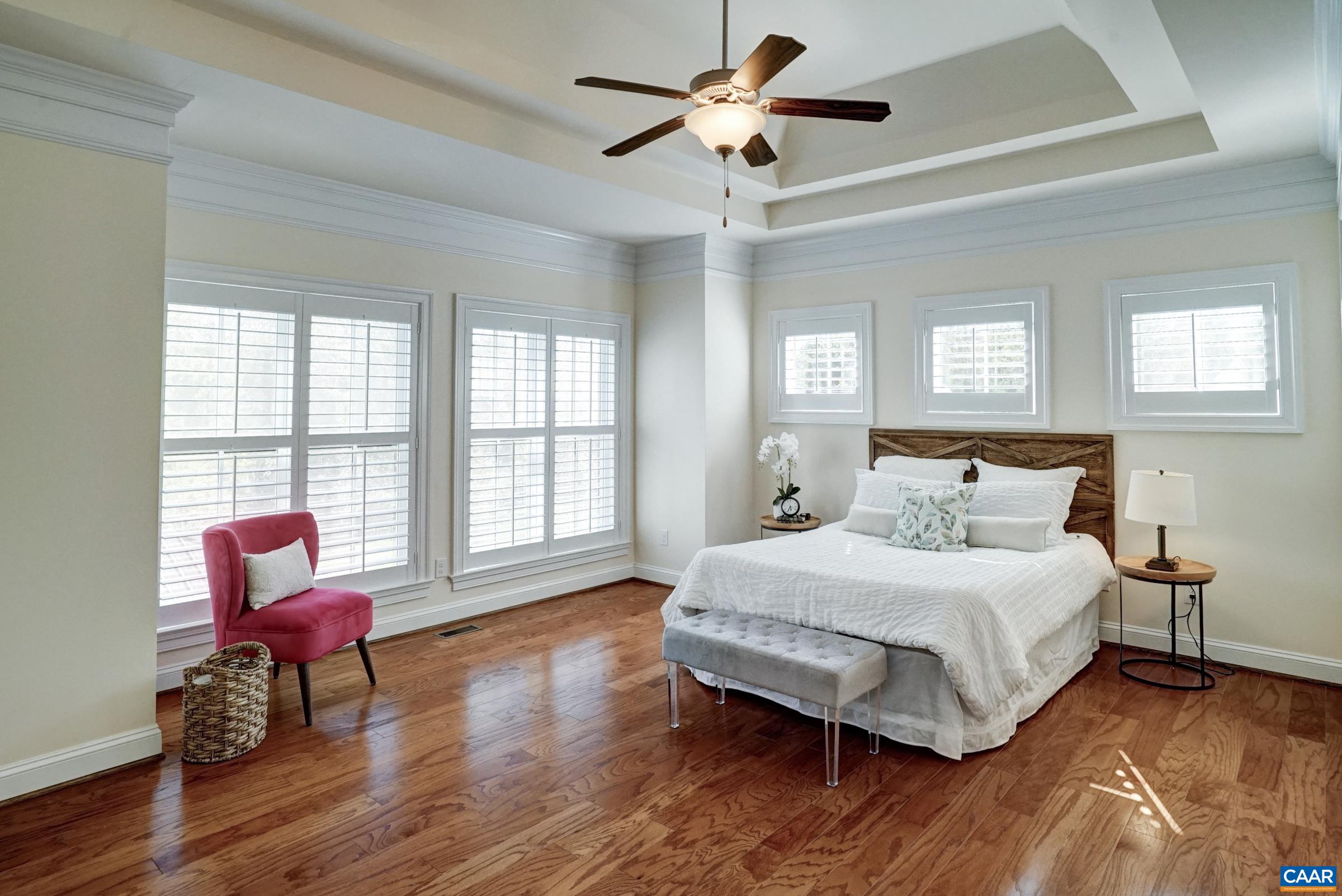 Main level primary suite with tray ceiling. Main level primary suite with tray ceiling.