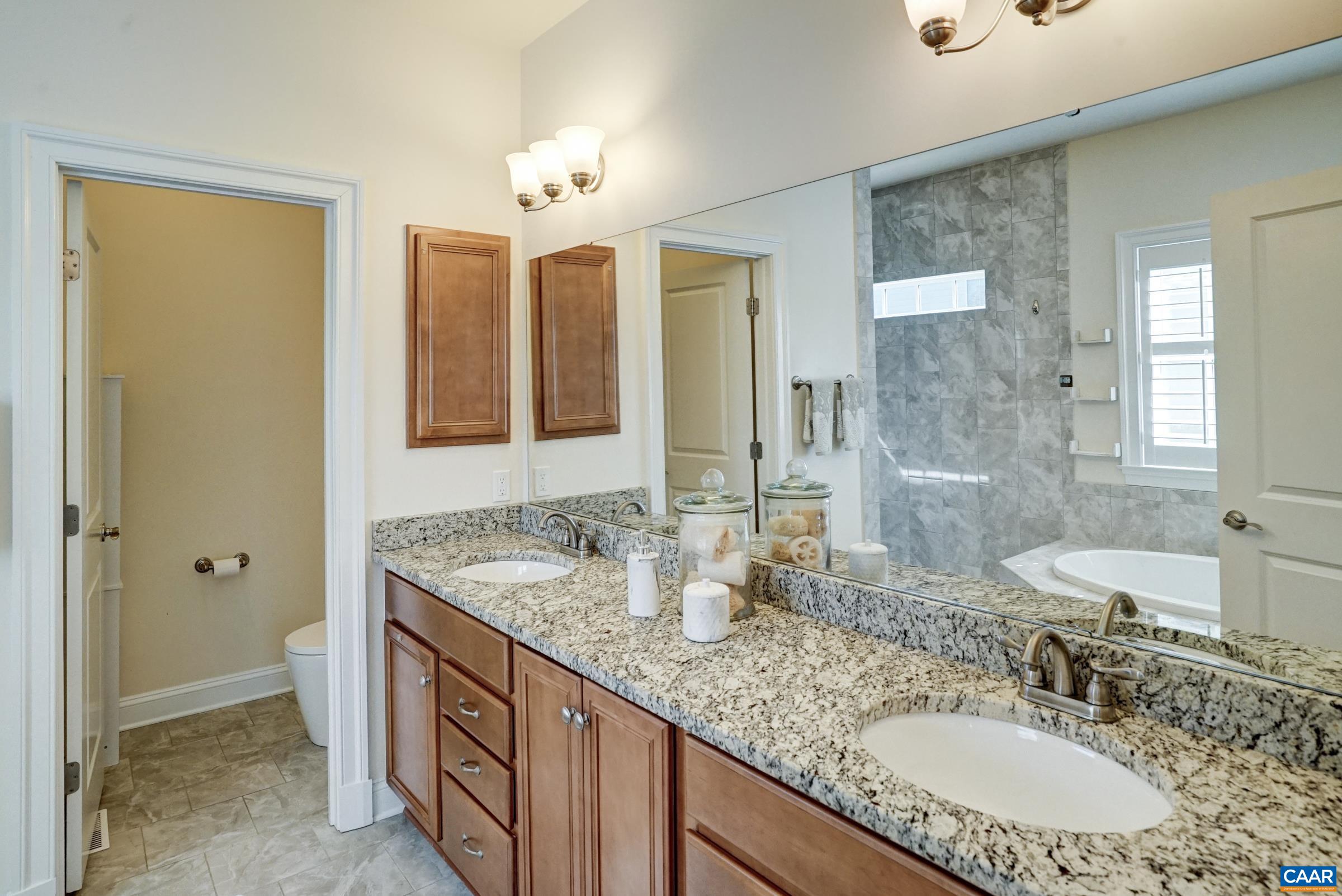 Primary bathroom features double sink granite vanity. Primary bathroom features double sink granite vanity.