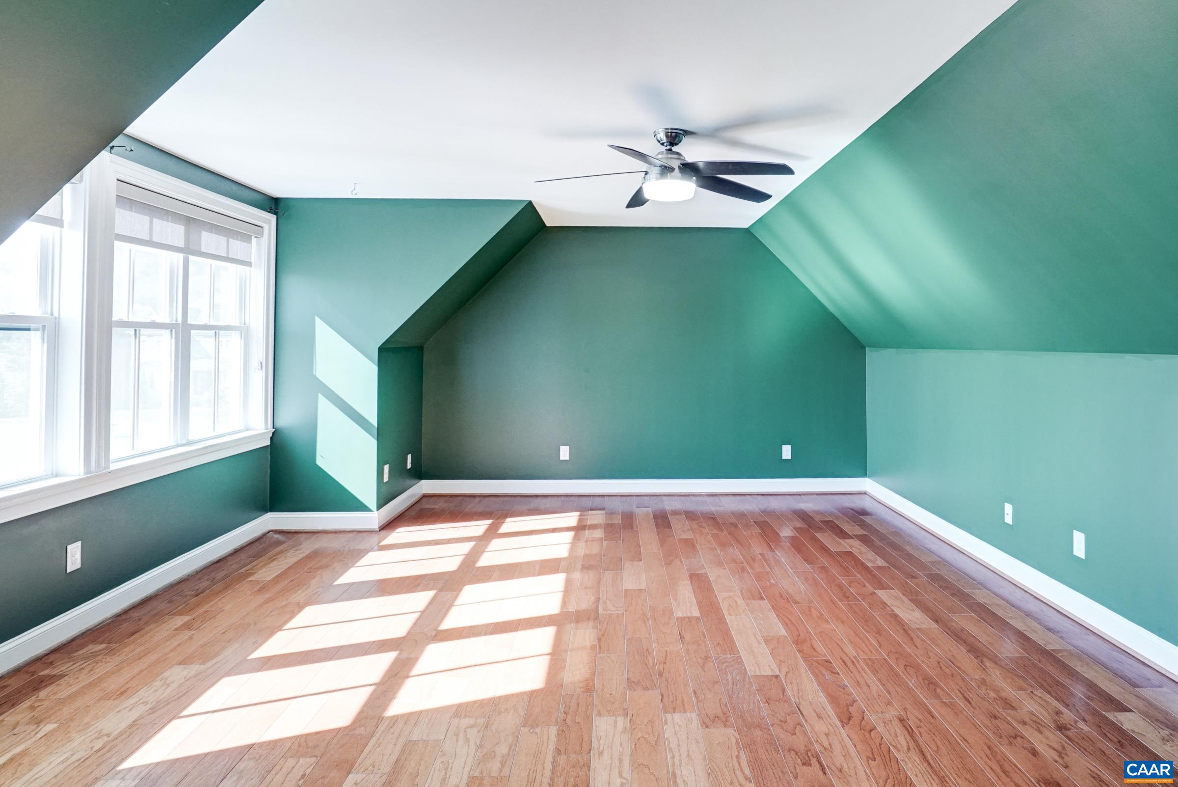 Second floor features a large loft space with LVP flooring, new mini-split HVAC, and ceiling fan. Second floor features a large loft space with LVP flooring, new mini-split HVAC, and ceiling fan.
