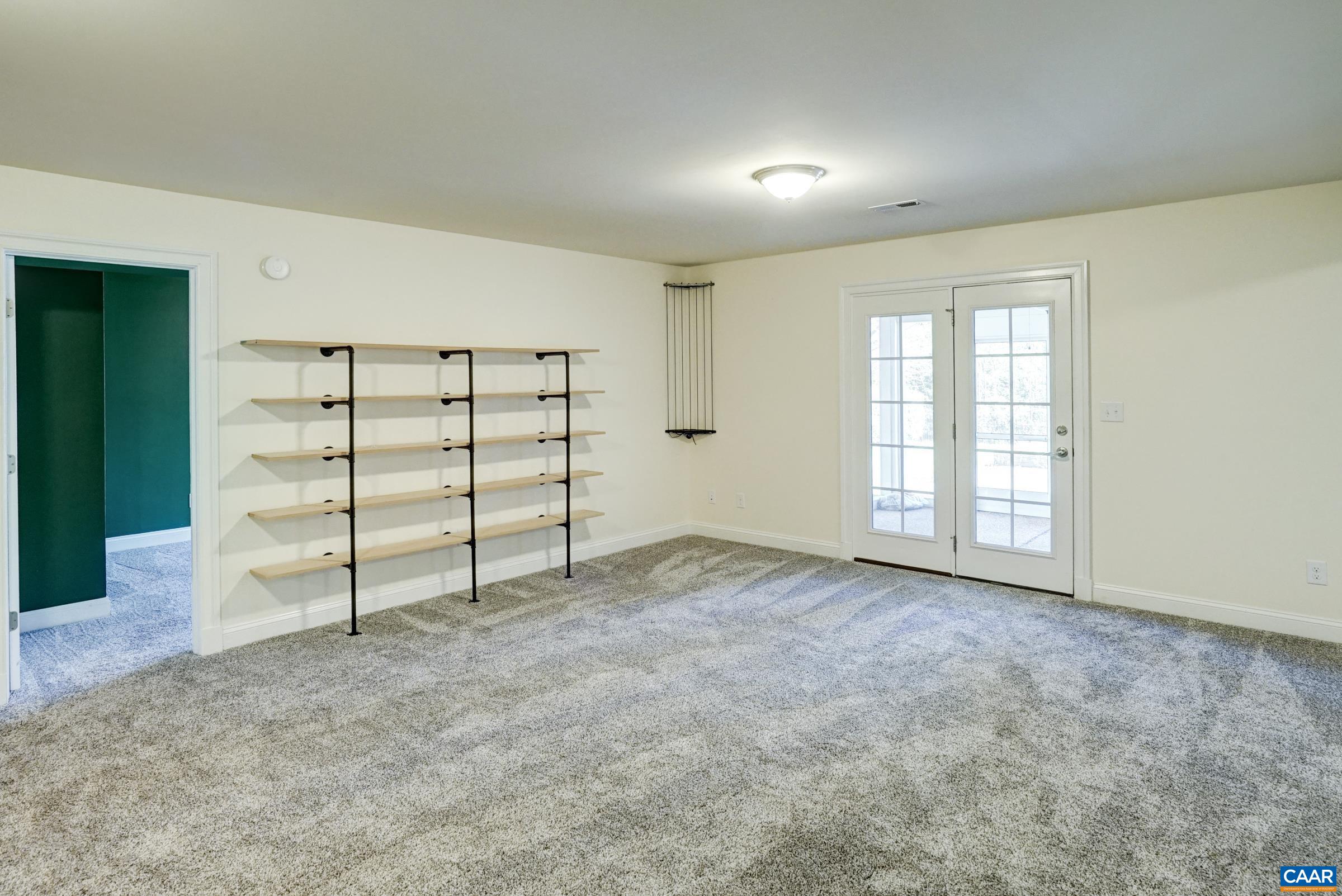 Walk-out basement features new wall to wall carpeting throughout plus storage shelves in the rec room Walk-out basement features new wall to wall carpeting throughout plus storage shelves in the rec room