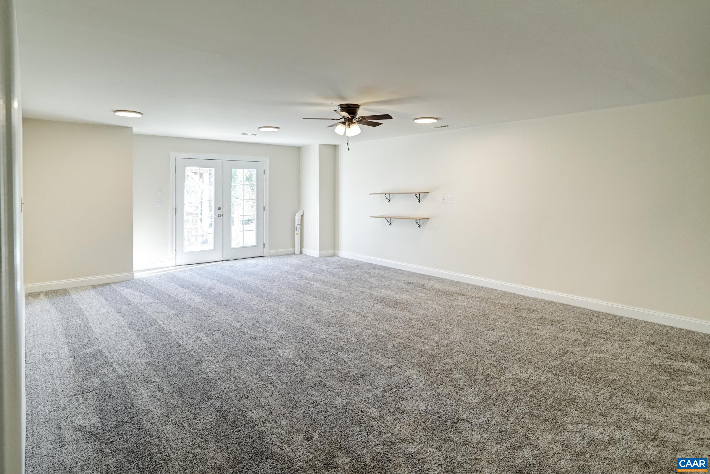 Spacious newly finished fifth bedroom in the basement features a ceiling fan and new lighting. Spacious newly finished fifth bedroom in the basement features a ceiling fan and new lighting.